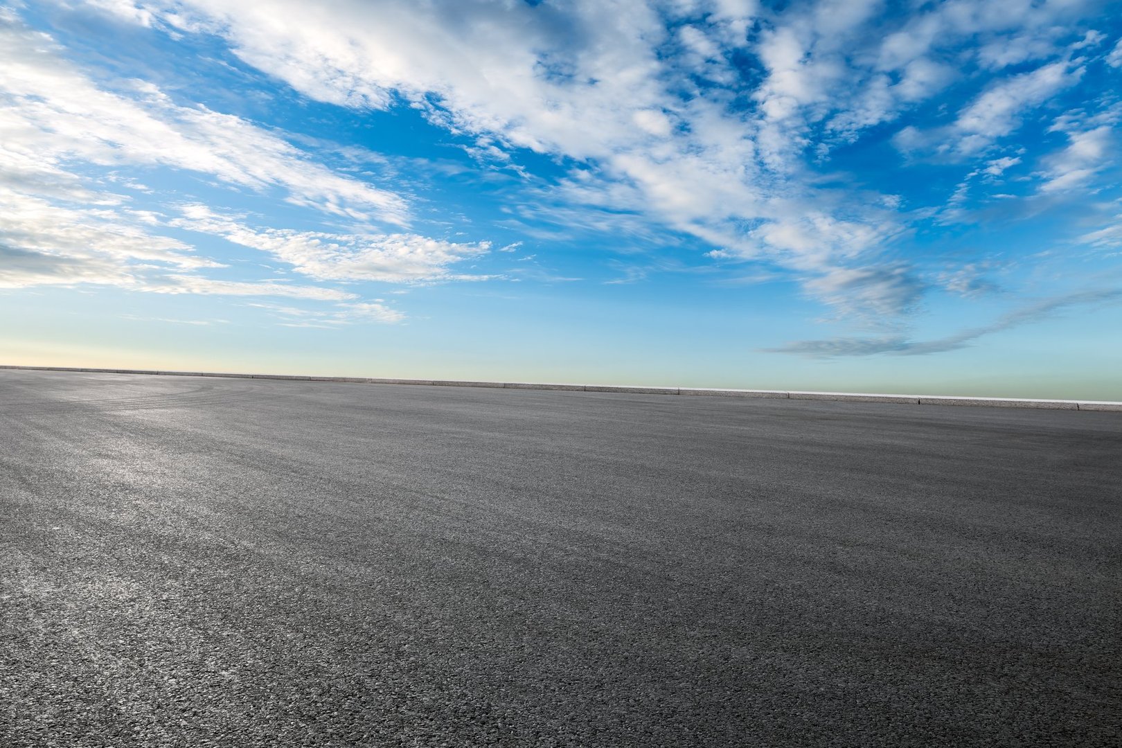 Empty asphalt road and cloudscape on sunny day