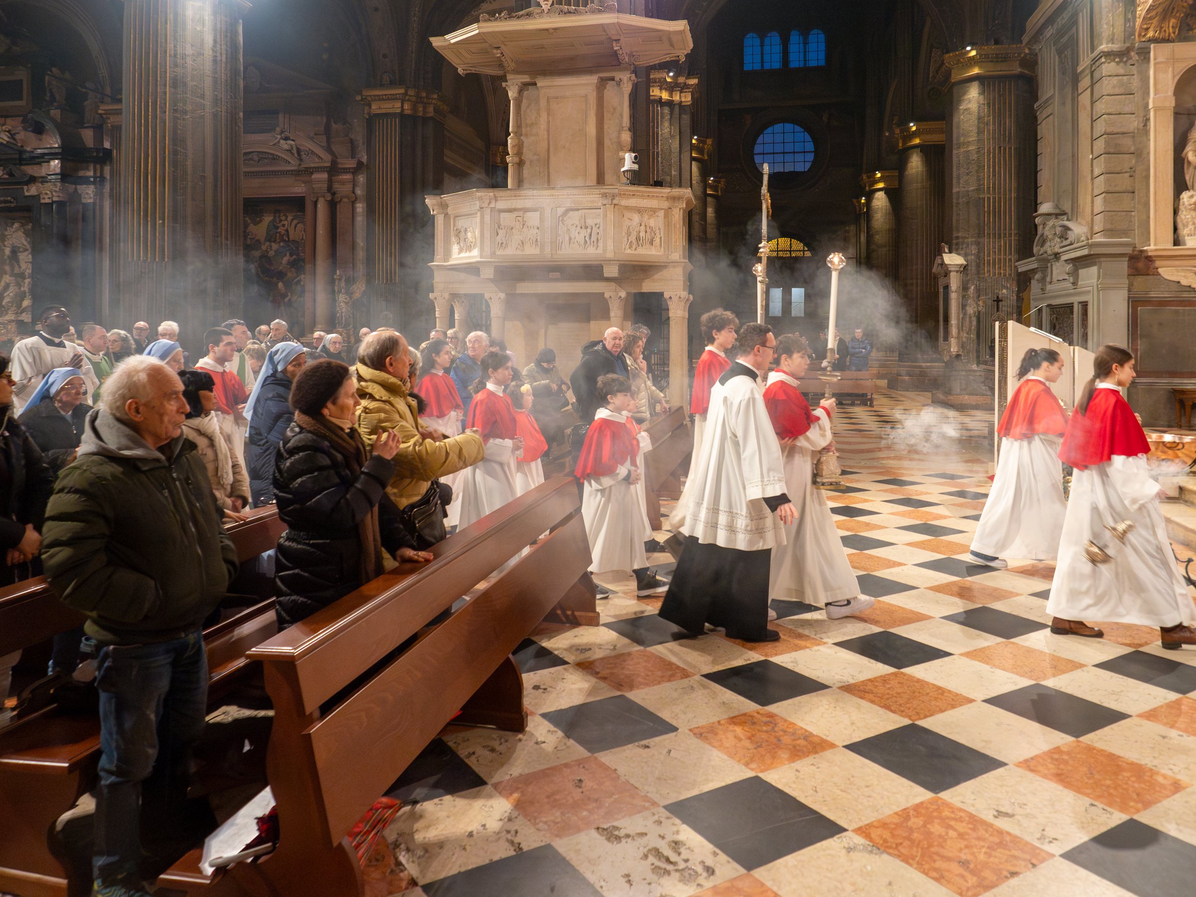 Cremona, Italy - February 9th 2025 Altar boys walking in procession during a catholic mass in the Cathedral of Santa Maria Assunta in Cremona, Italy, with believers attending the celebration