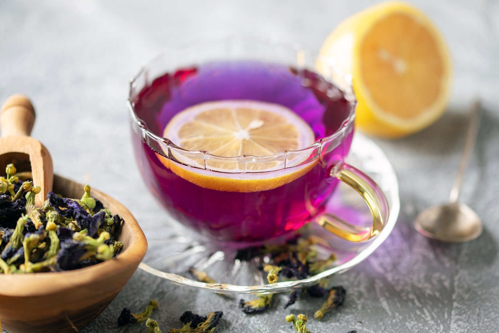 Blue tea Anchan or Butterfly pea in glass cup with dry flower of clitoria. Purple tea with lemon. Asian drink