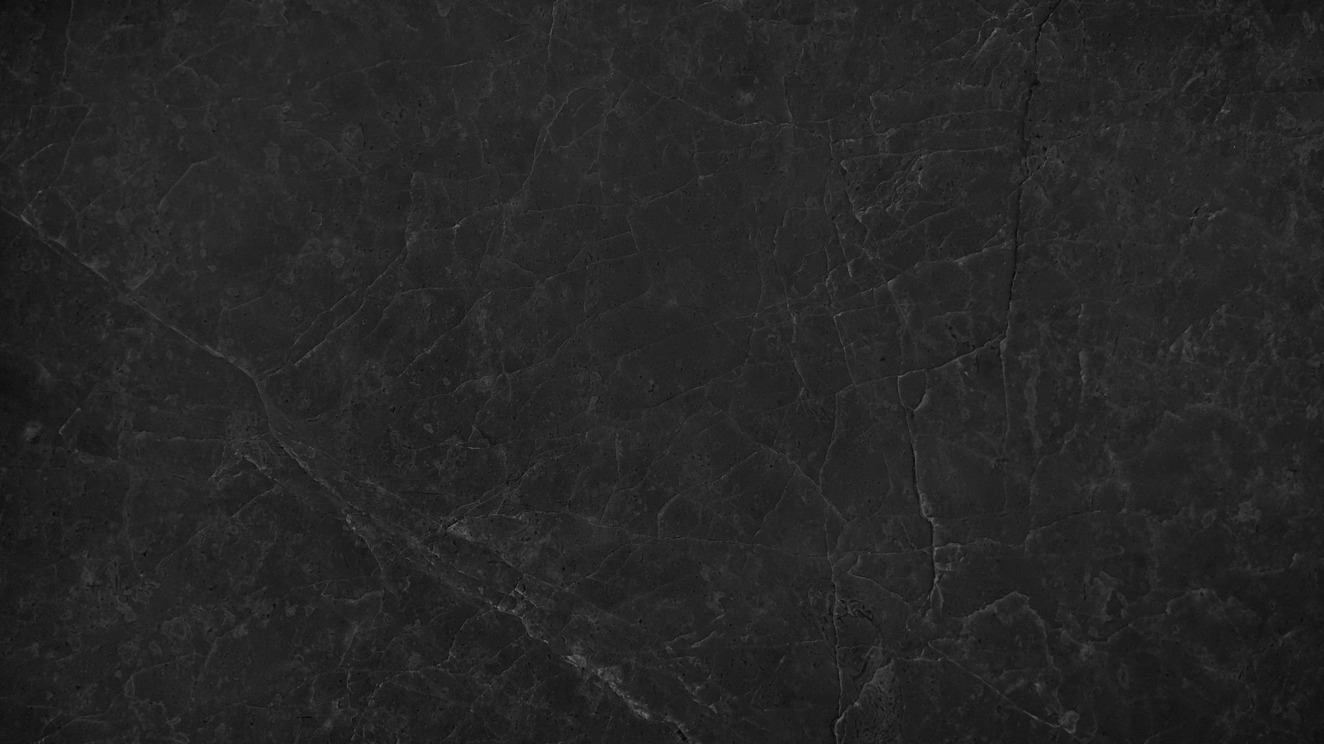 image presenting a close-up view of a slab or tile of black marble, showcasing its natural veining patterns and smooth, dark black polished surface, suitable for use as a background design projects.