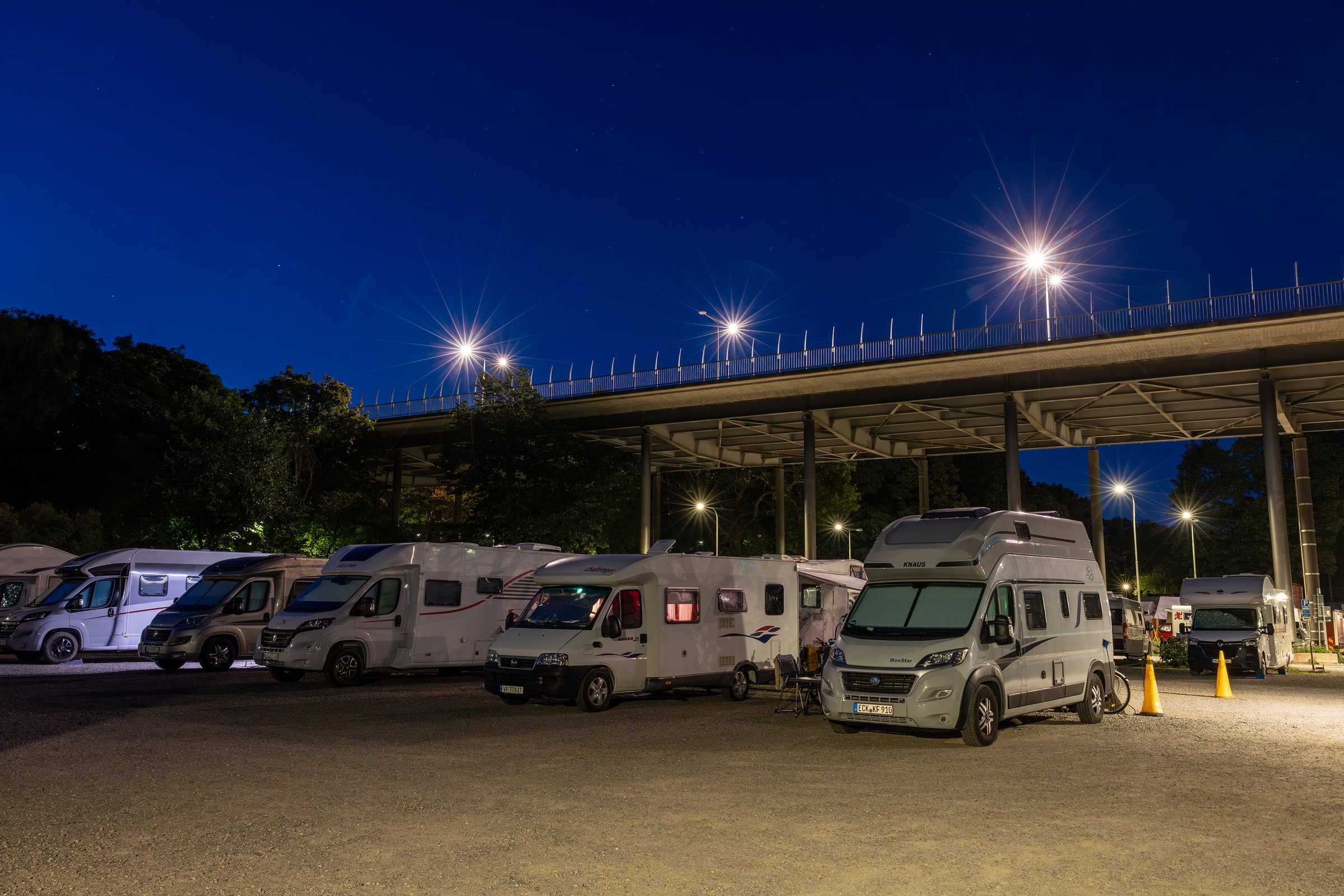 Stockholm, Sweden Aug 1, 2024 Motor campers parked under a bridge in the downtown on Langholmen island.