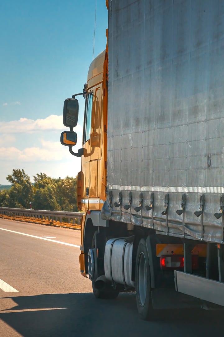 Yellow commercial semi-truck on highway