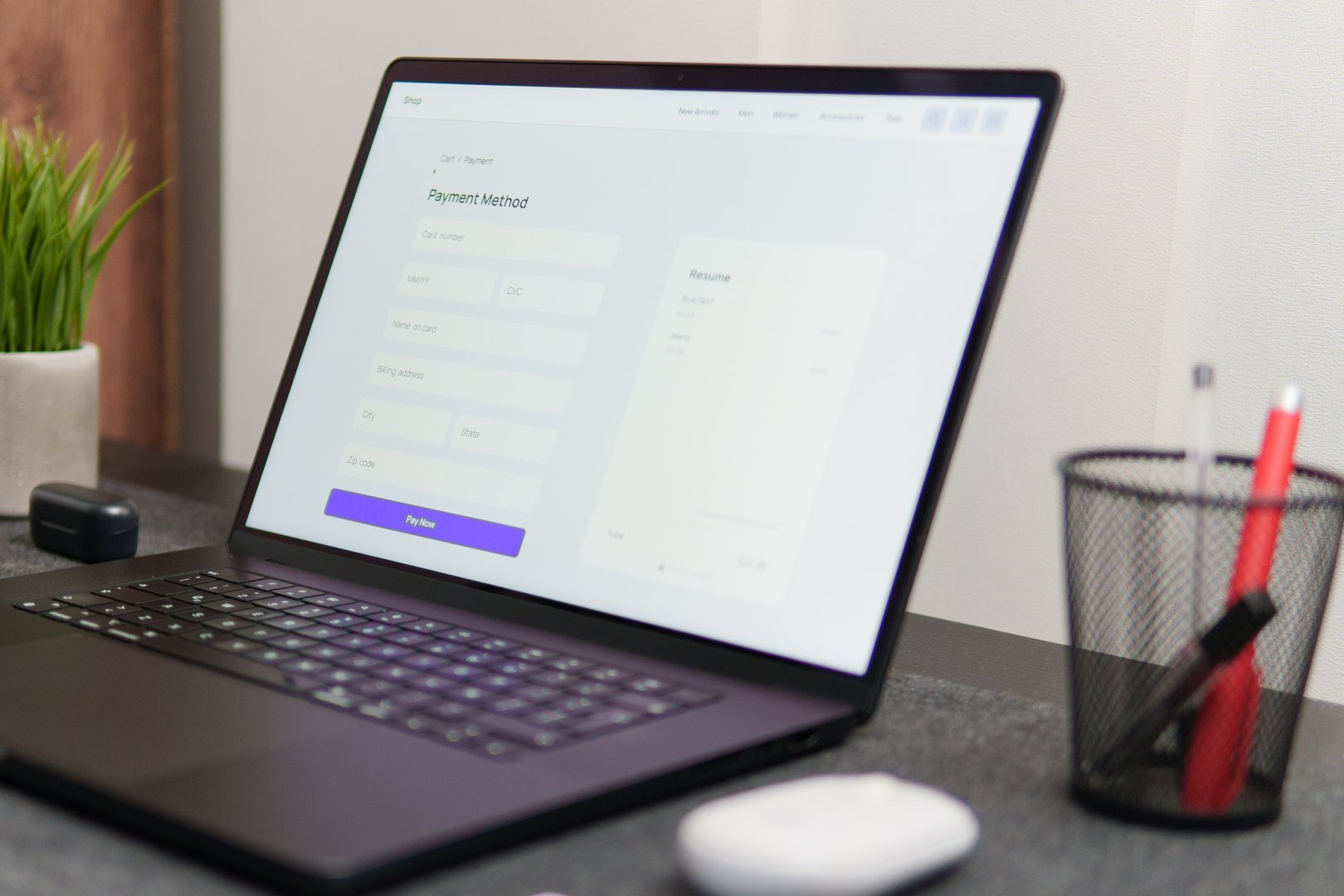 Modern laptop displaying payment method form on desk in contemporary office setting, ready for online transaction