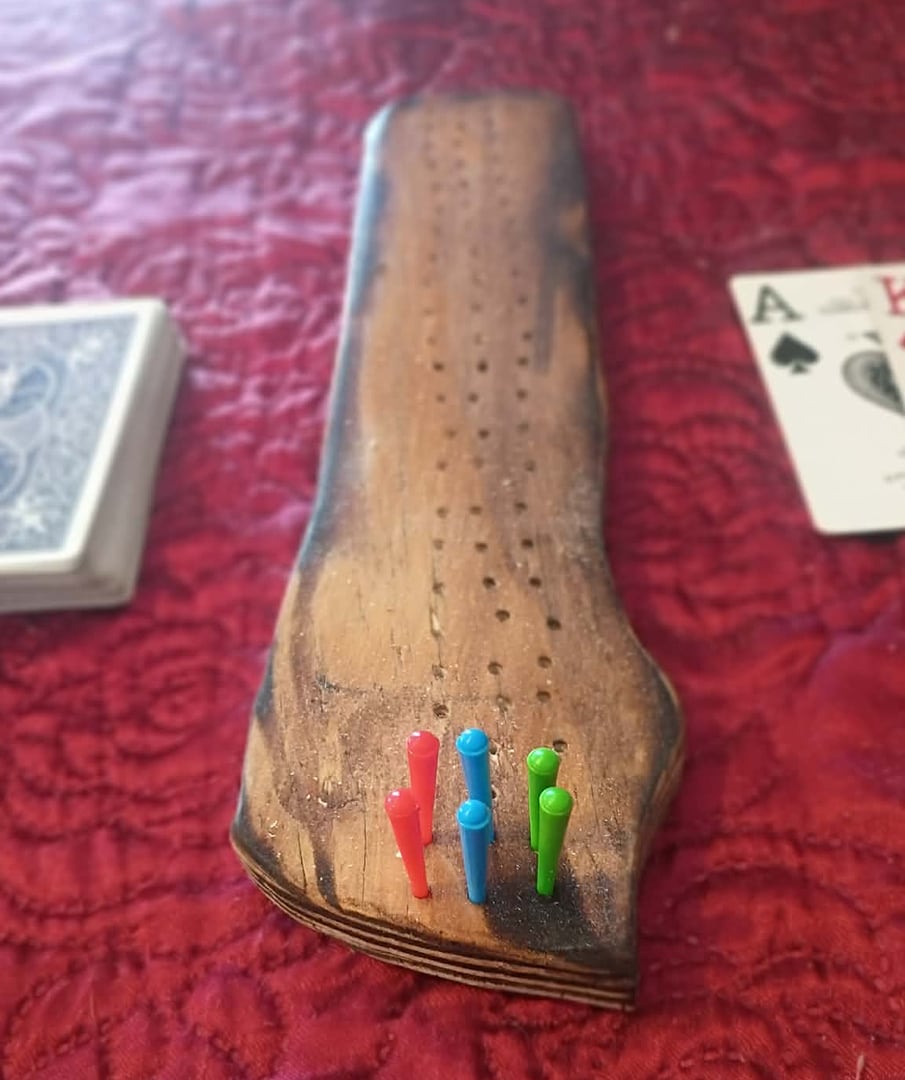 Hand-torched wood cribbage board from Maine