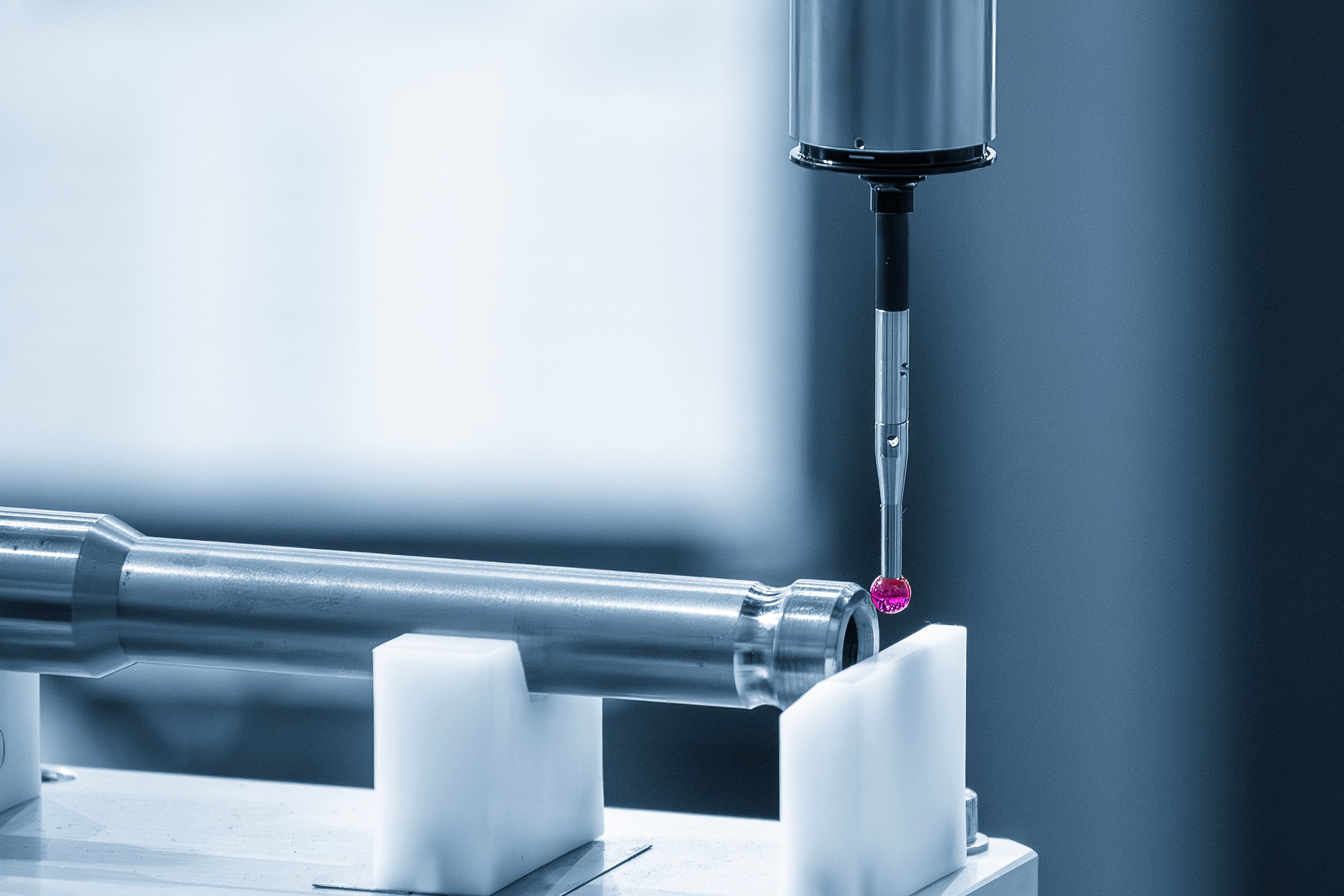 The CMM machine measuring the automotive parts in the blue tone. The quality control of automotive parts with CMM machine.