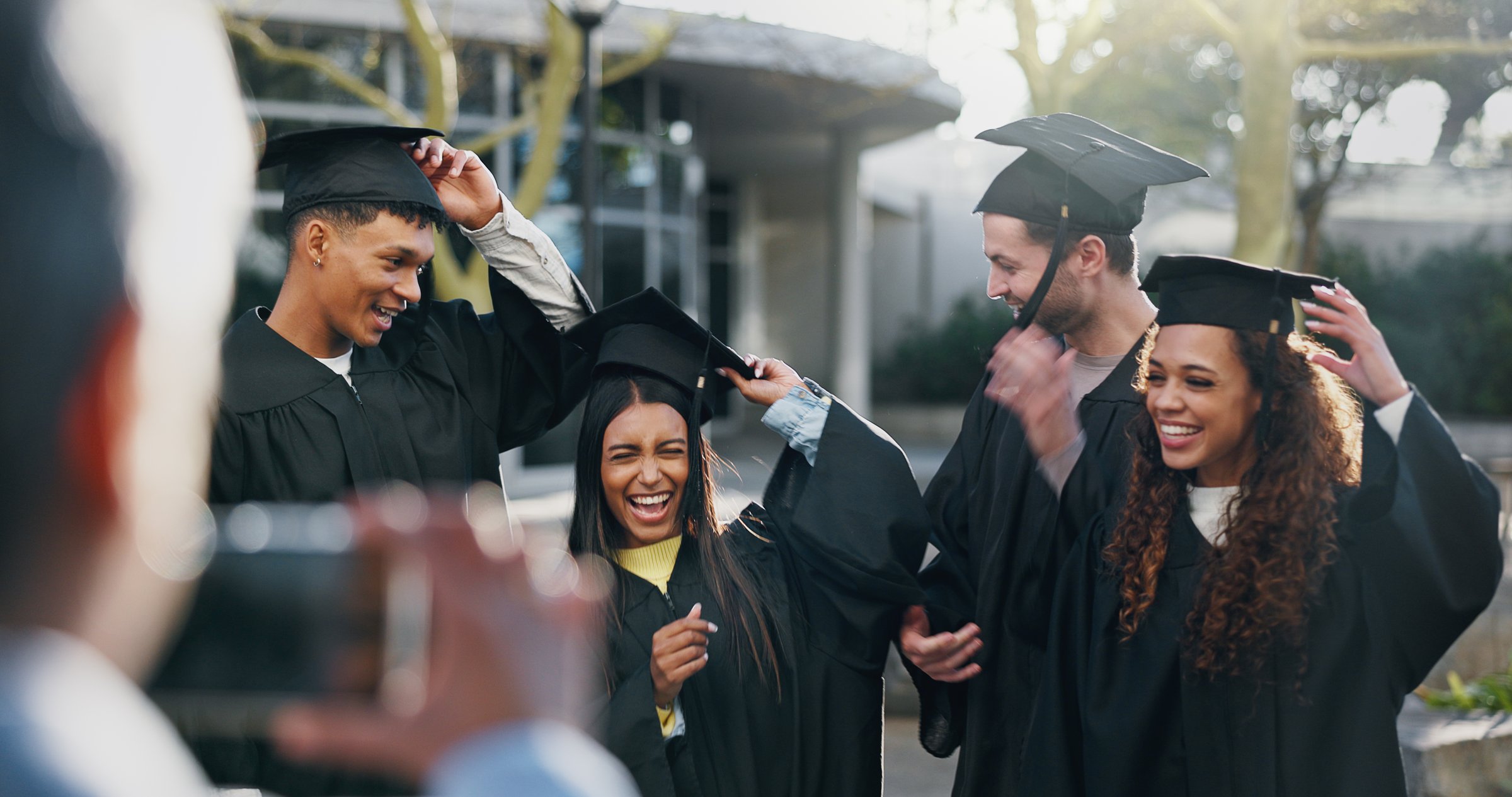 Students, graduation or happy at university for photography, fun or hats for achievement. Friends, class or excited outdoors for event, academic success or taking picture for yearbook or local news
