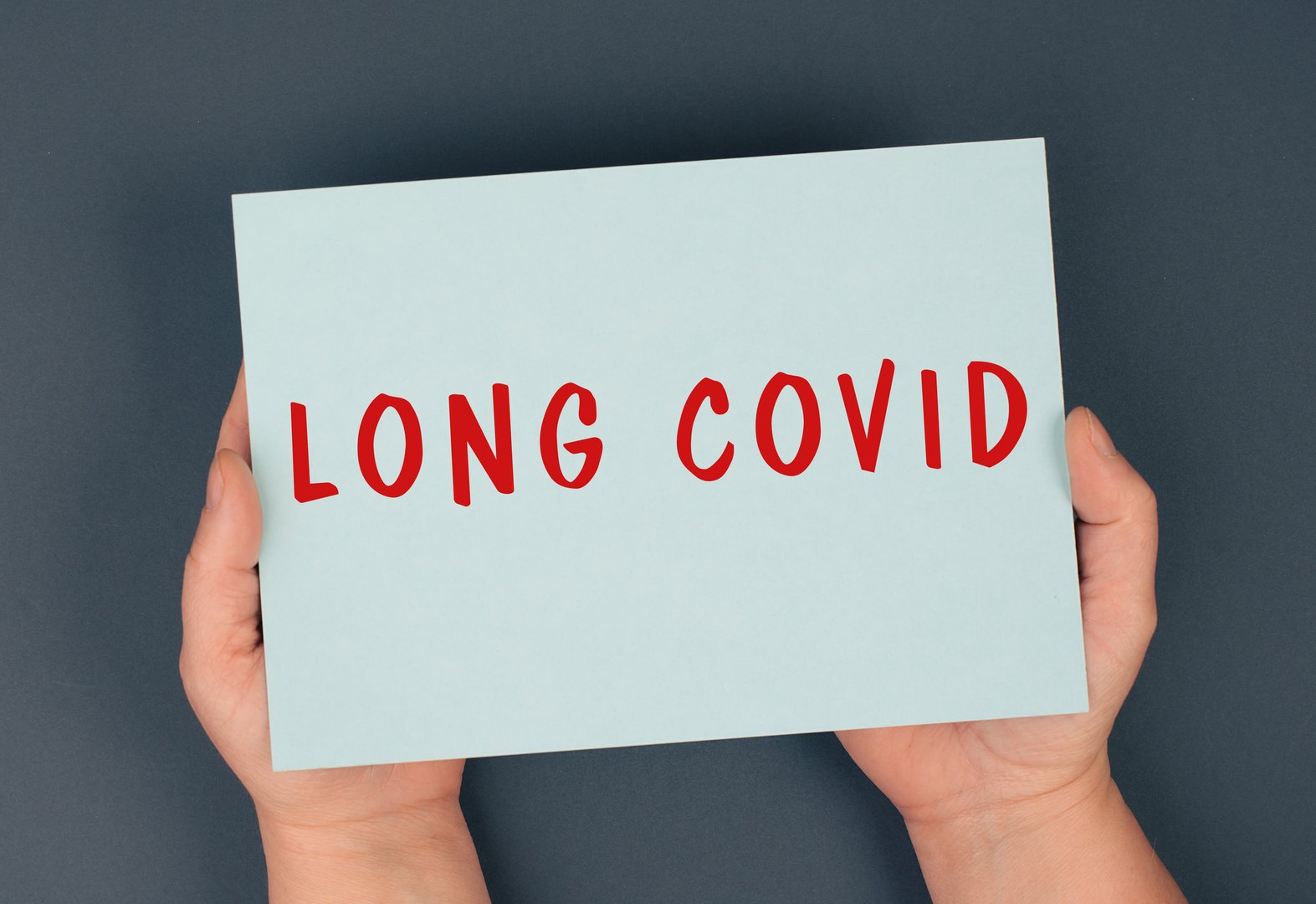 The words long covid are standing on a paper, health problems after Covid-19 disease