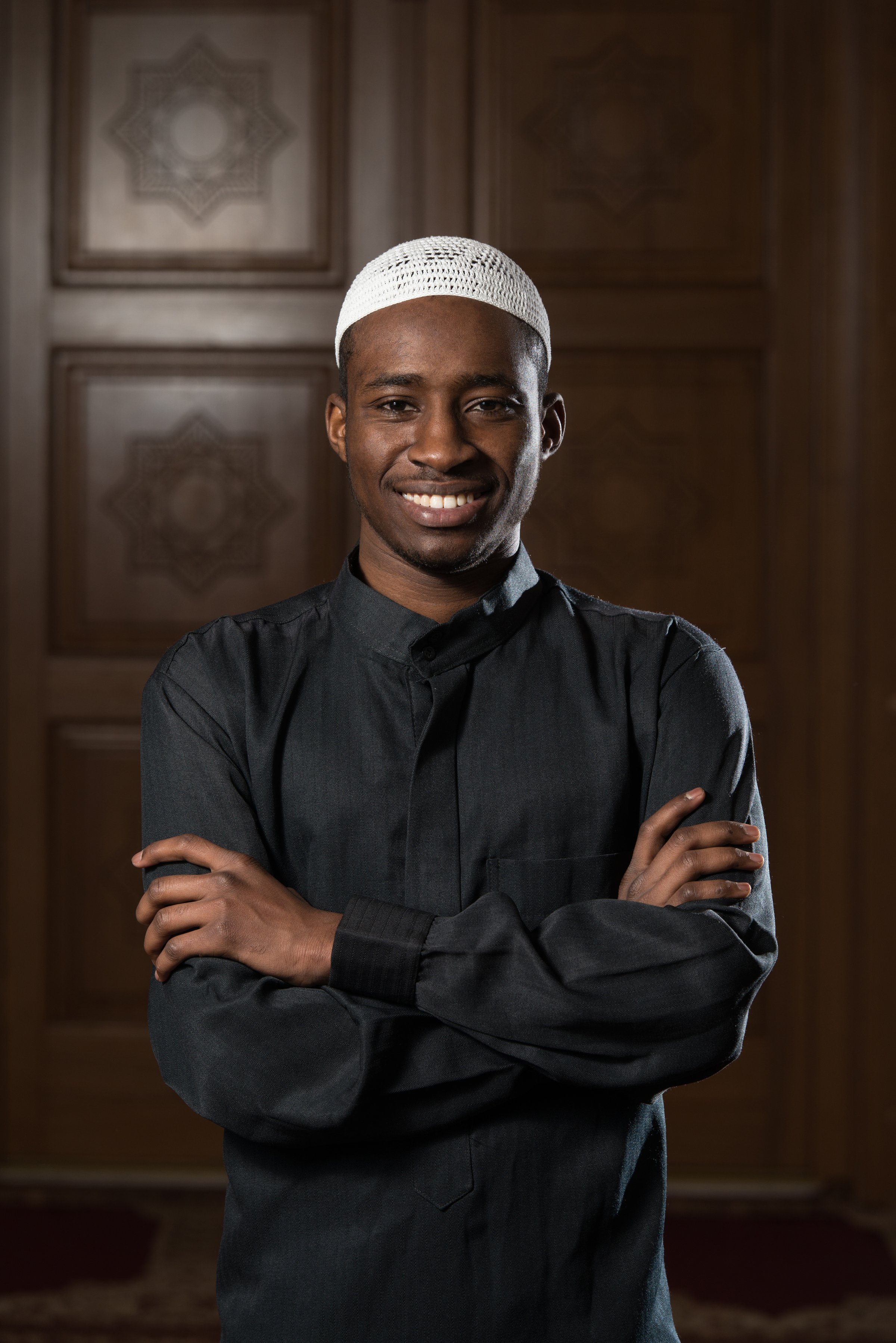 African Muslim Man Making Traditional Prayer To God While Wearing A Traditional Cap Dishdasha