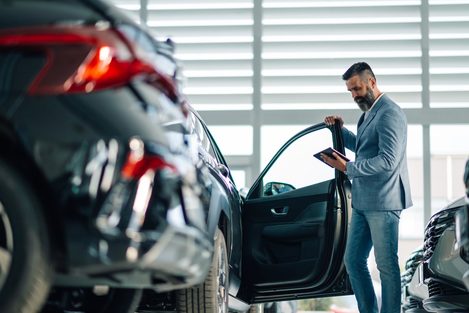 Business Professional Examining a Car