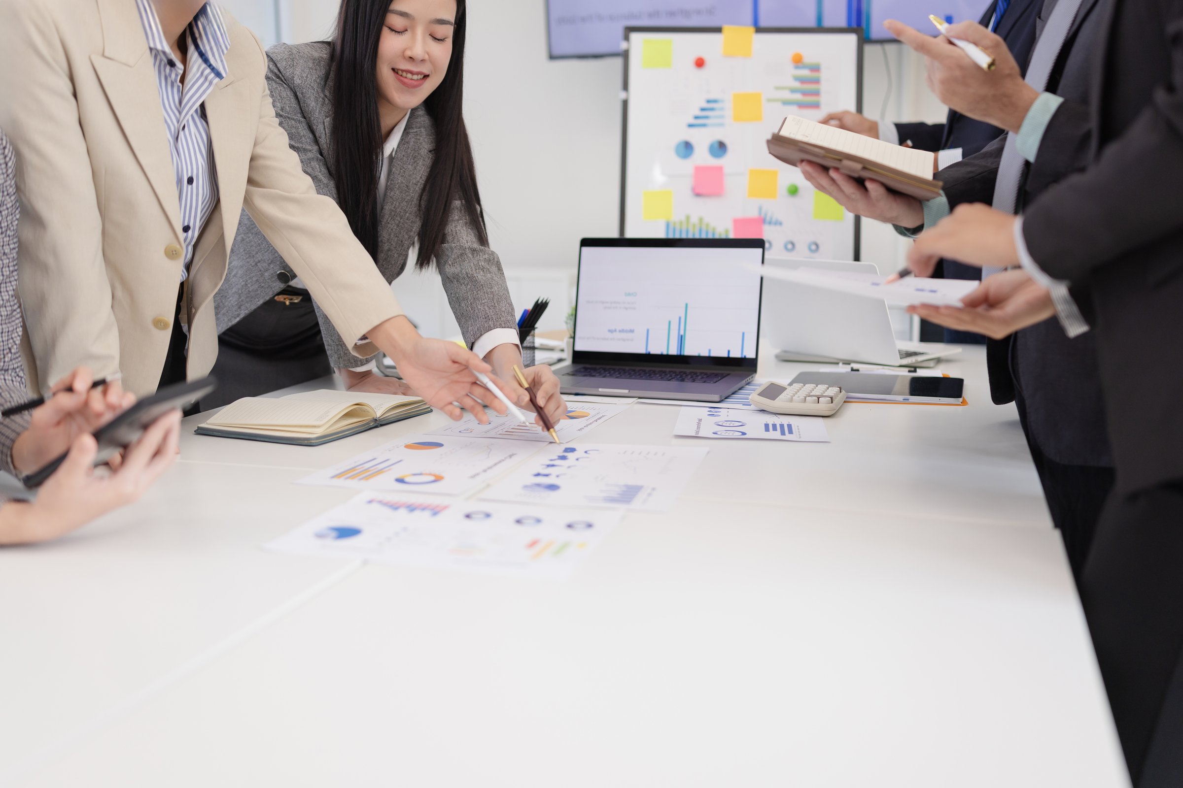 Group of businesspeople working plan analysis project brainstorm in modern office, Asian businesspeople team working together, Business startup and company strategy planning concept.