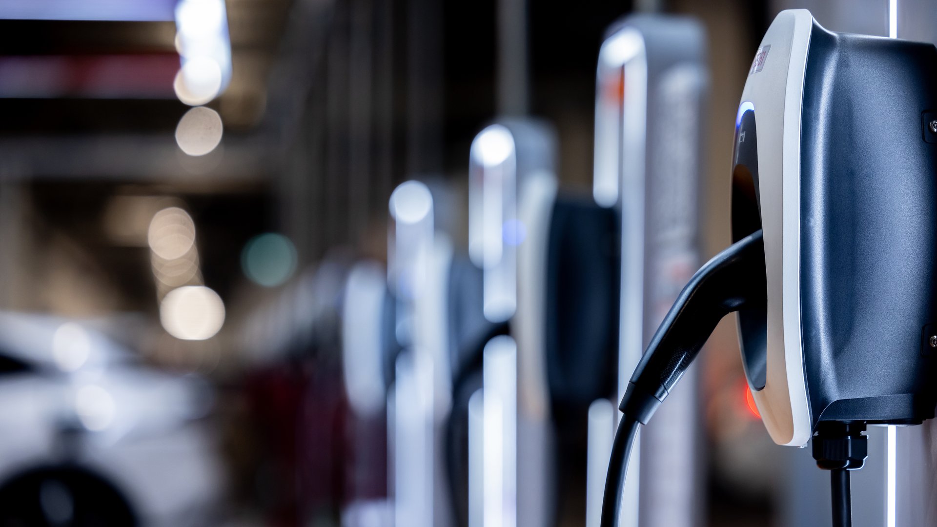 EV charging station and electric car, Electric car charging station for charge EV battery, Plug for vehicle with electric engine, EV charger clean energy, Charging point at car parking lot.