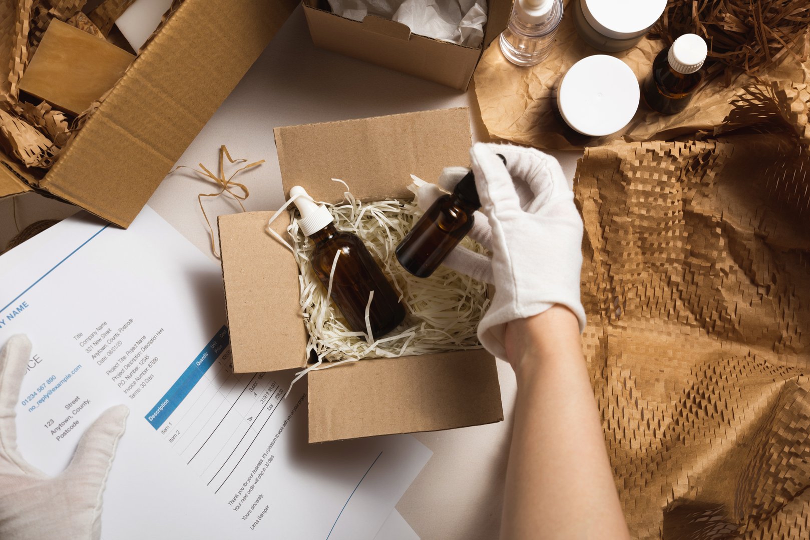 Beauty box with serum bottles on shredded white paper. Eco-friendly cardboard gift box with zero-waste cosmetics products. Online retail store orders in the delivery service warehouse.