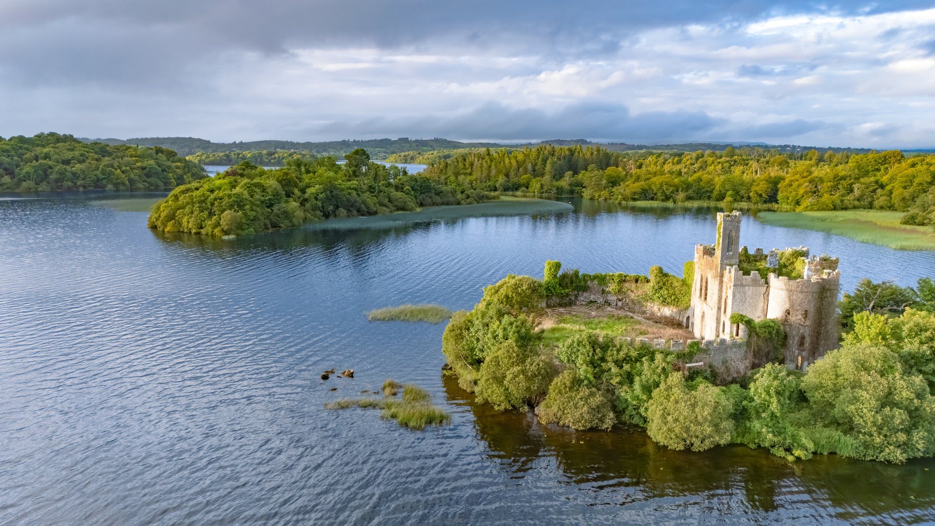 Aerial drone view of McDermotts Castle on small island in Lough Key lake, county Leitrim, Ireland