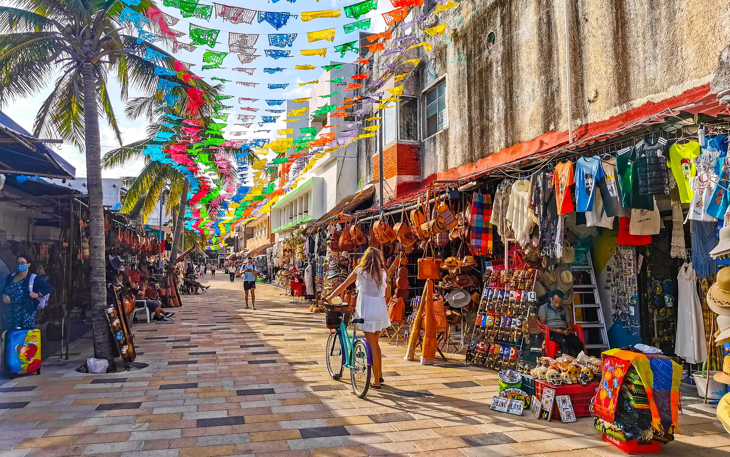 Typical street road and cityscape of La Quinta Avenida with restaurants shops stores people souvenirs and building in Playa del Carmen Playa del Carmen Quintana Roo Mexico.