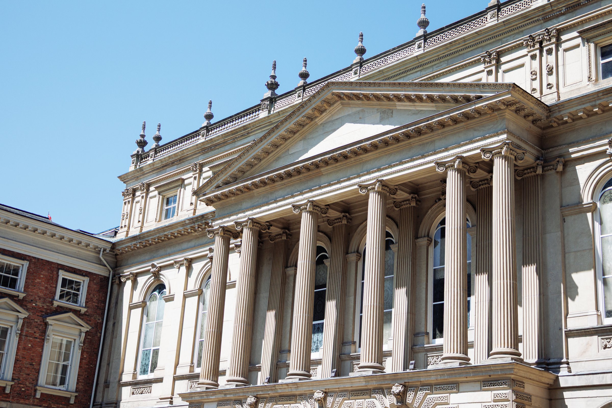 Osgoode Hall historic courthouse with classical architecture framed by trees in downtown Toronto, Canada.