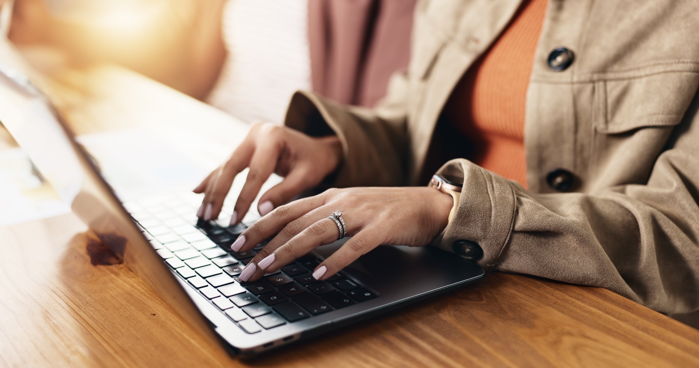 Laptop, hands and businesswoman in office with communication, email or contact for investment. Technology, typing and female financial manager with computer for online finance report in workplace.