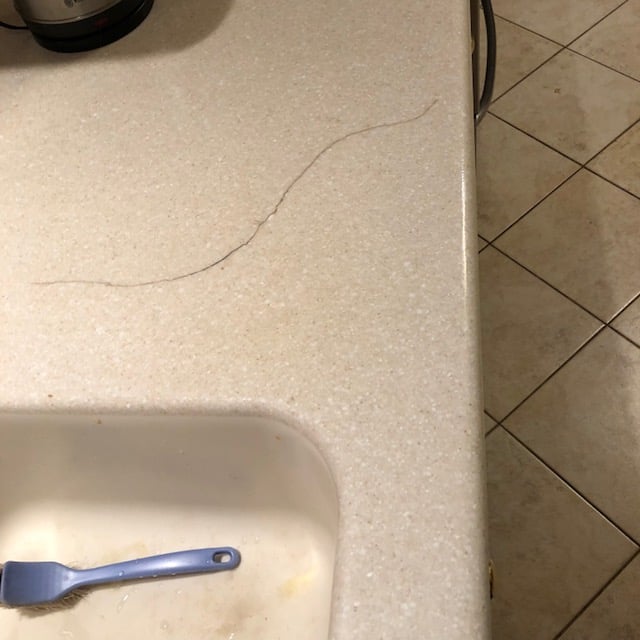 Corian crack repair before near me - damaged solid surface countertop needs professional restoration NY CT NJ Manhattan Long Island
