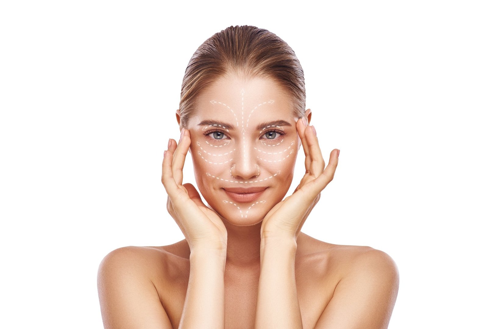 Anti-aging facial massage. Beautiful young woman with white arrows over her face keeping hands on head and looking at camera. Isolated on white background. Skin Care. Massage lines. Cosmetology concept