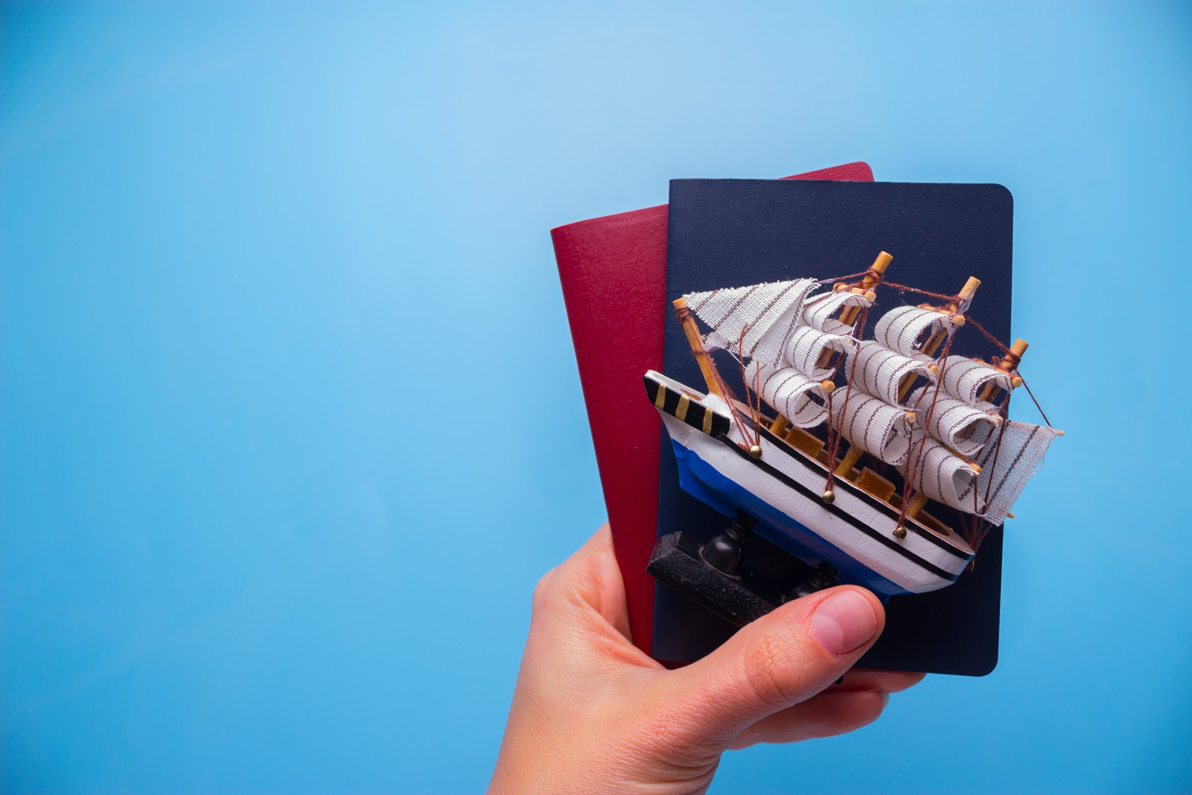 passport on blue background. travel abroad concept