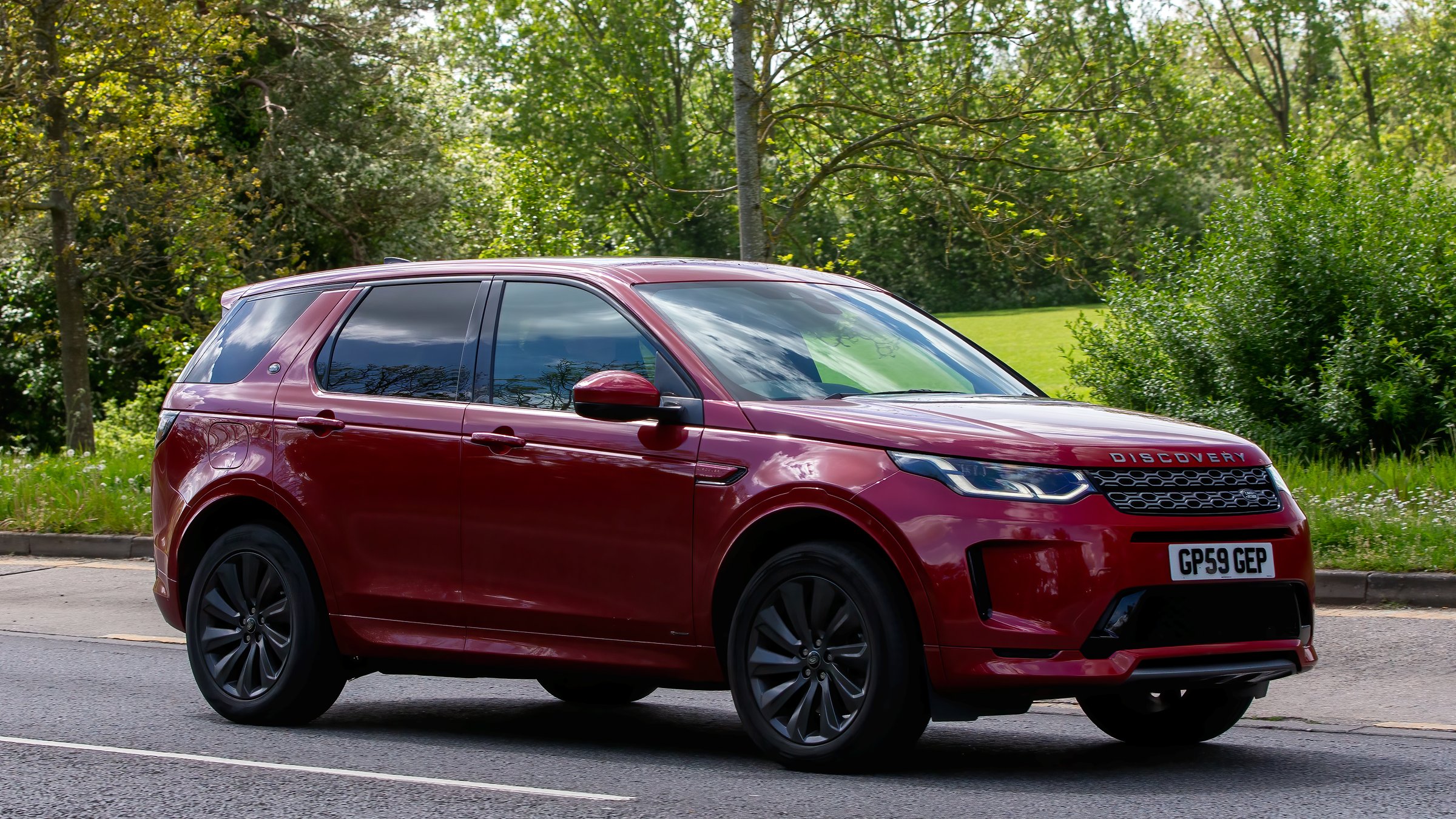 Milton Keynes,UK - May 5th 2024: 2020 red Land Rover Discovery Sport  car driving on a British road