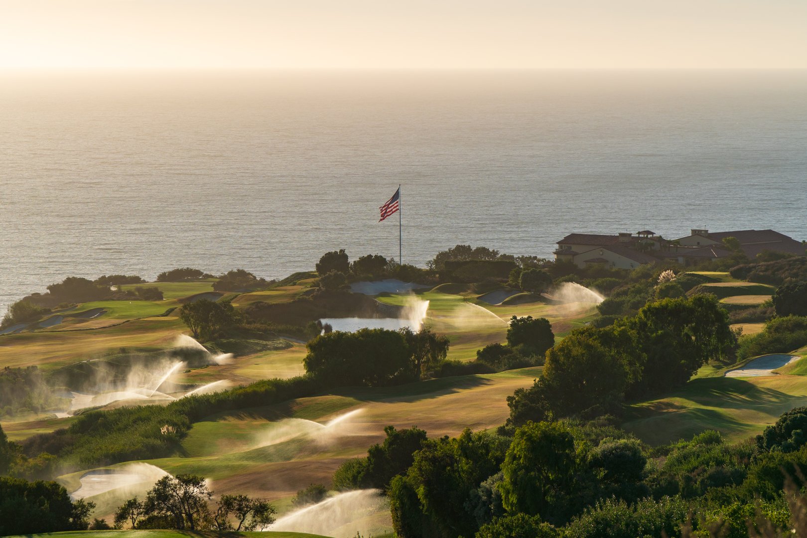 The Trump National Golf Course, in Rancho Palos Verdes along the Pacific coast of California, at sunset, with ongoing watering.
