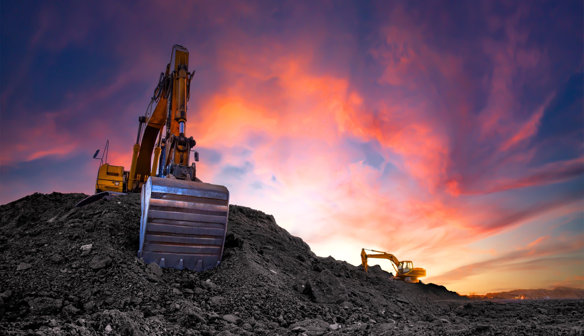 Coal mining in an open-pit. Excavator on Coal mining. Excavator digging in open pit coal mine. Excavator in open-pit on sunset background. Heavy machinery in opencast. Earthmover on earthmoving