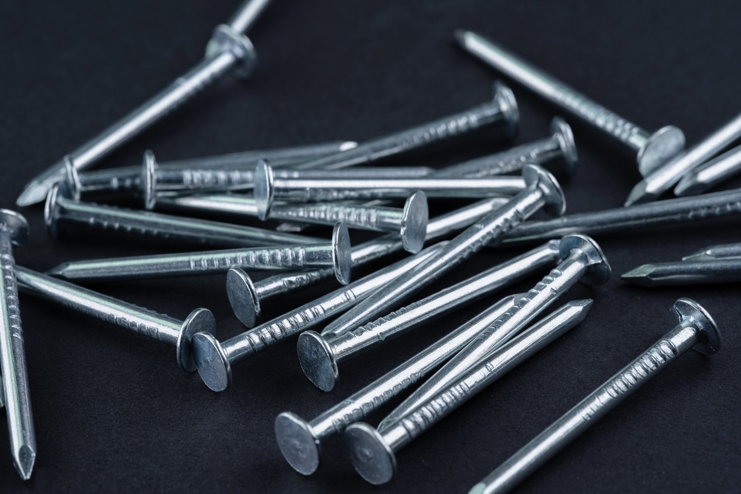 Metal nails on a black background