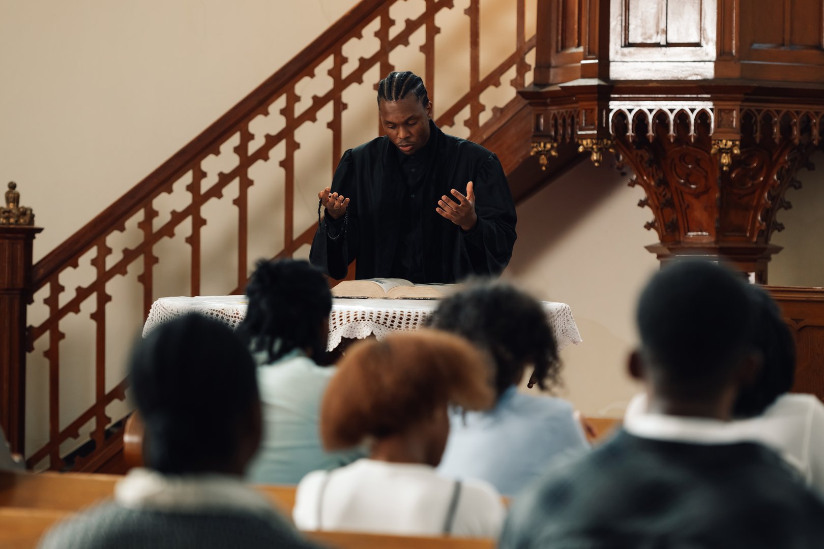 Priest giving a sermon in a peaceful church, parishioners praying and listening attentively, creating a warm and inviting atmosphere of faith and community