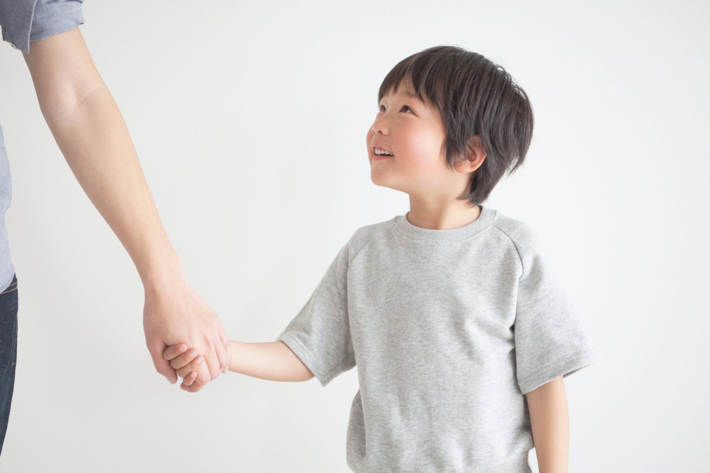 Smiling boy holding hands