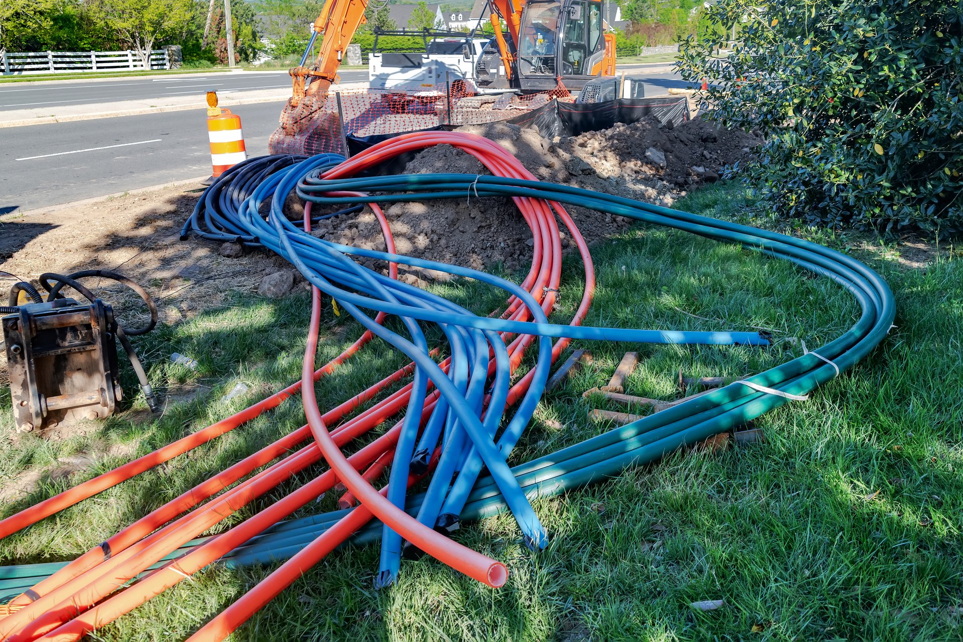 Plastic cables, excavator and equipment for laying broadband internet cables.