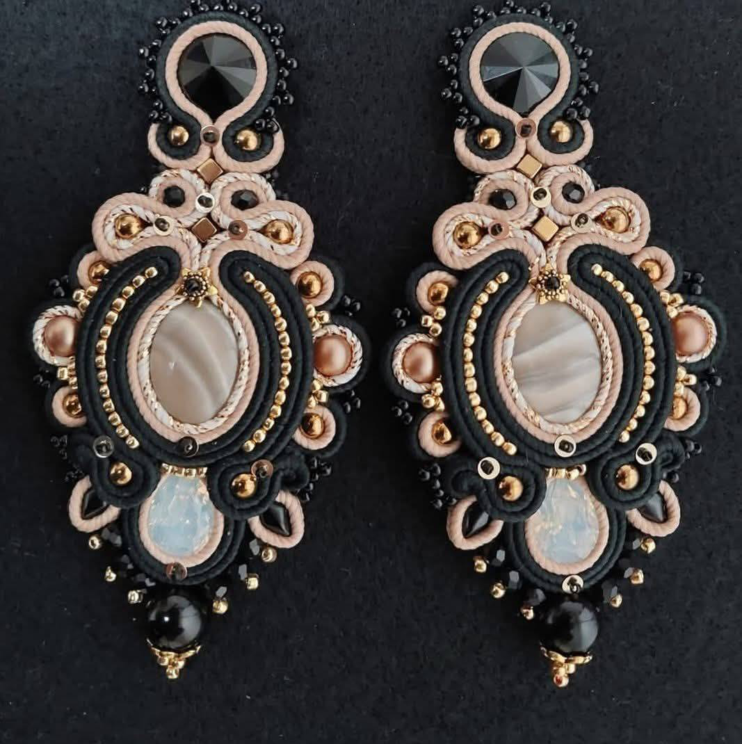 Beaded braselet and earrings set. Pink and blue soutache jewelry with flowers on the white wooden background. Women accessories