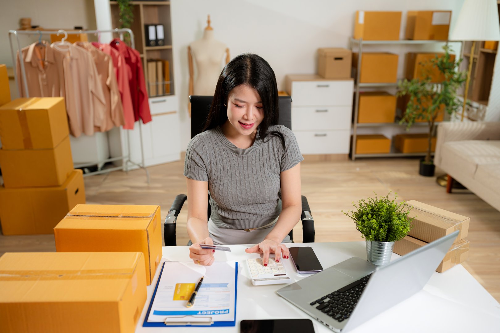 Concept of selling products online.entrepreneur or freelance checking orders from customers, woman runs an e-commerce business on websites and social media.