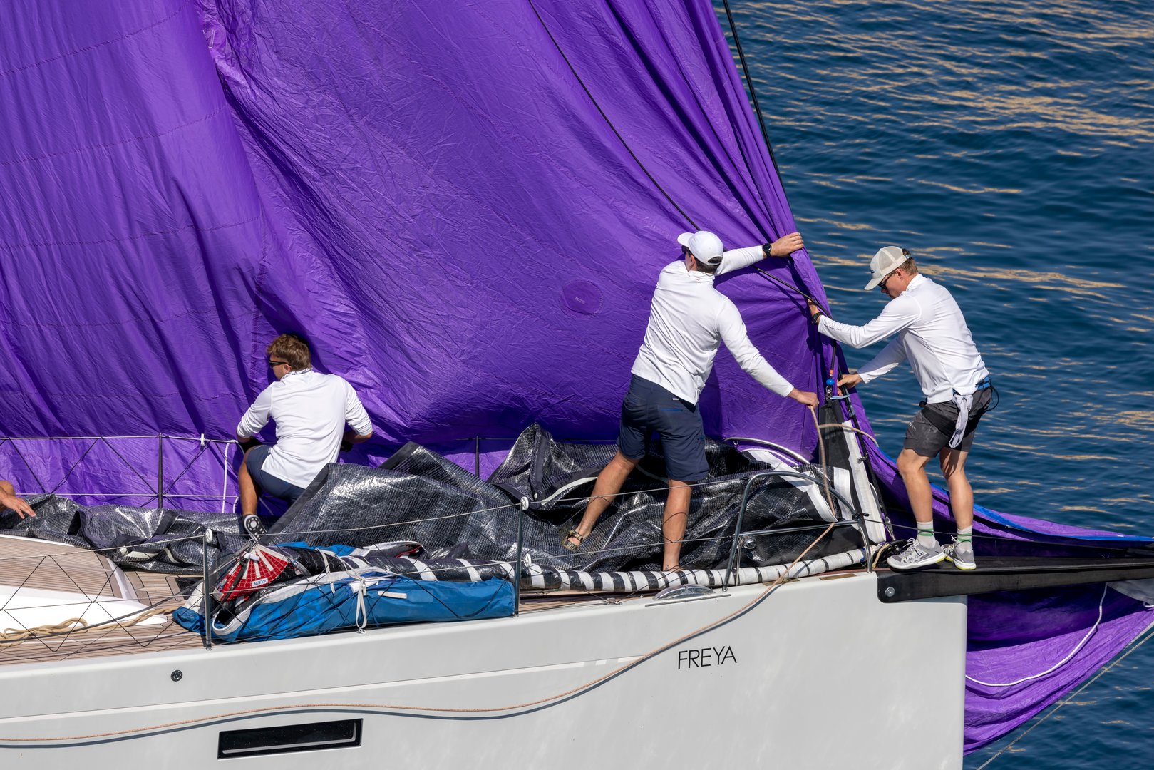 Grand Harbour, Malta - October 22, 2022: Crew of the Yacht Freya handling the sails and spinnaker.