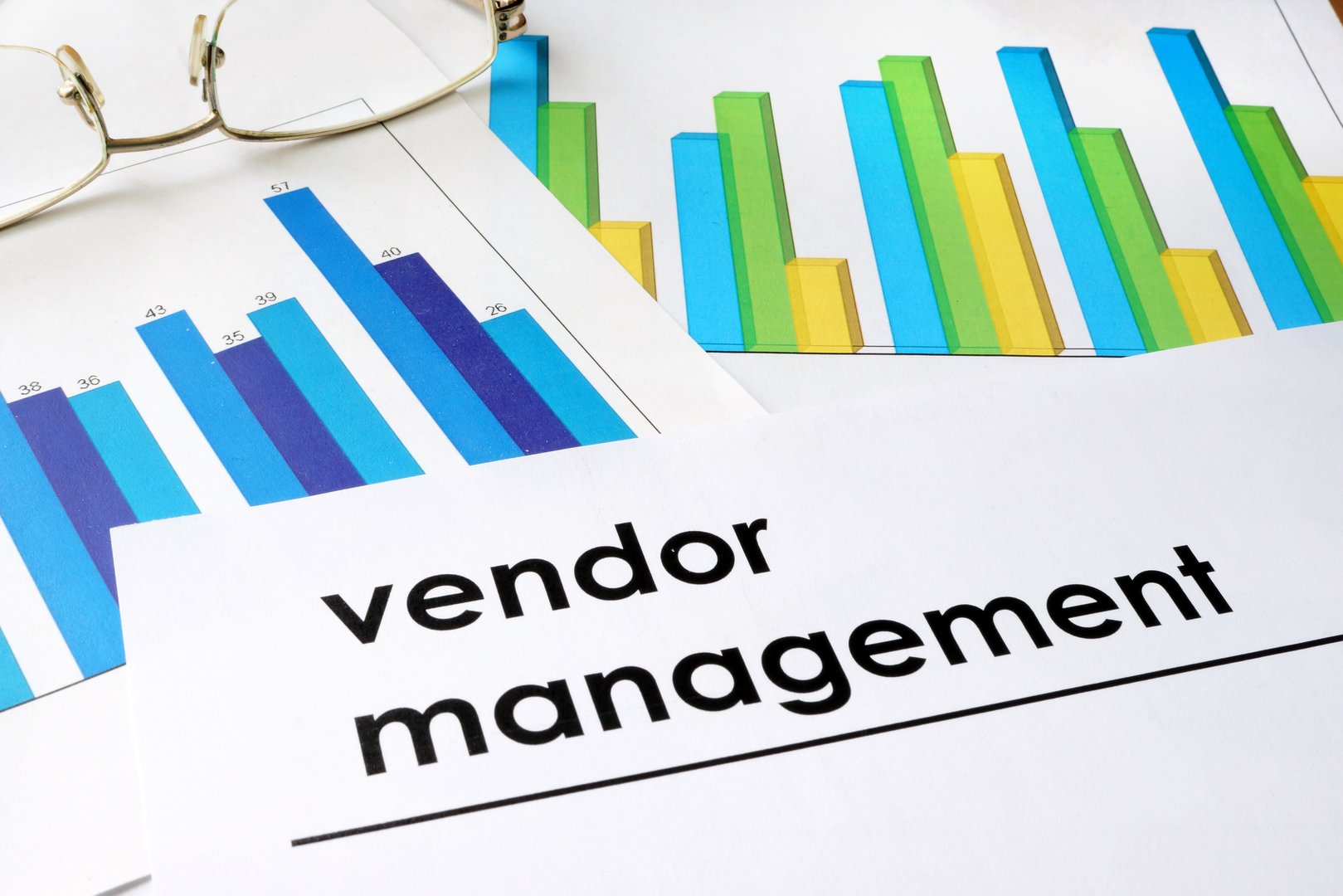 Paper with words Vendor management and charts.