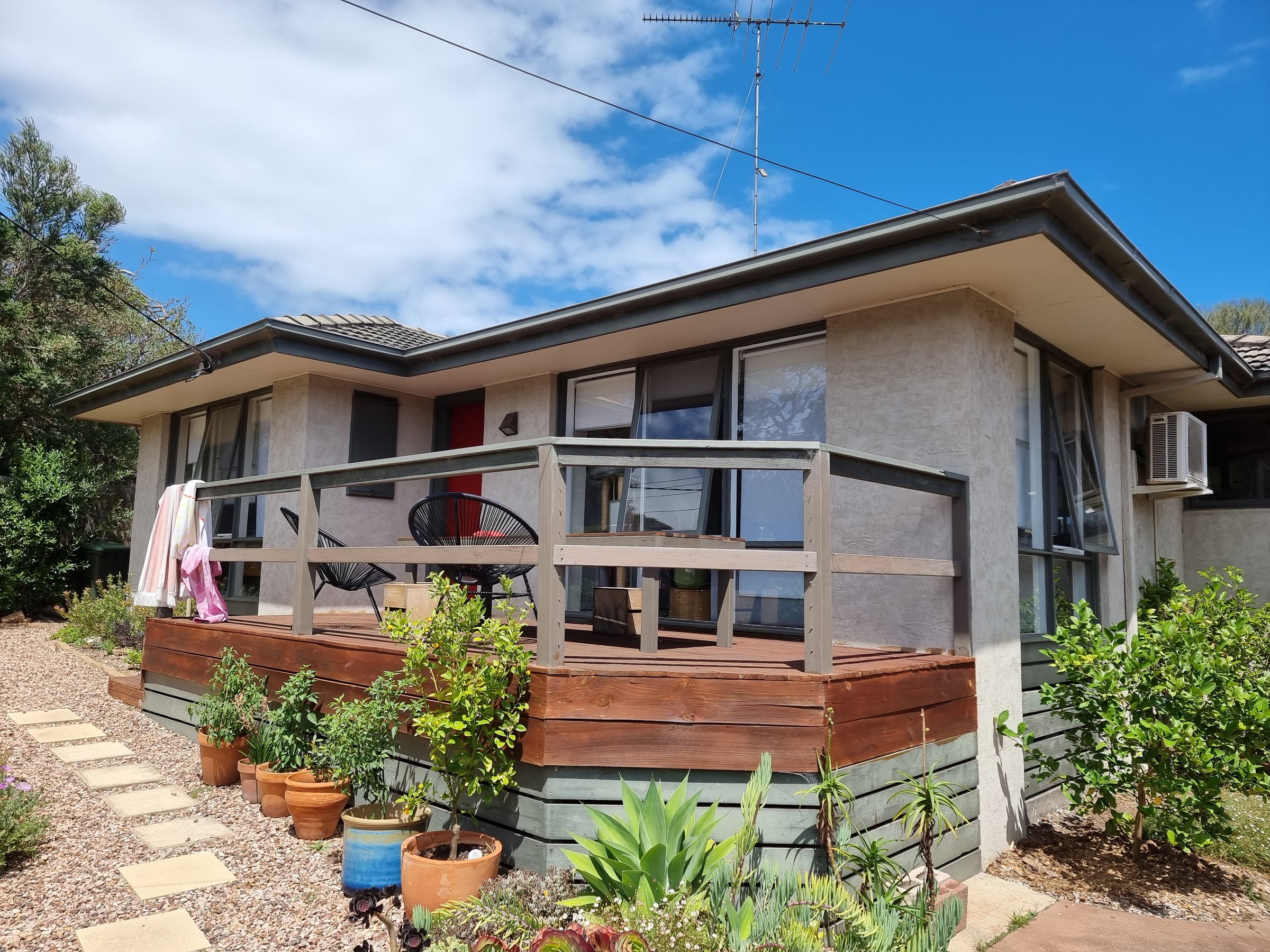 Contemporary family home exterior before painting transformation by Quality Painting Group