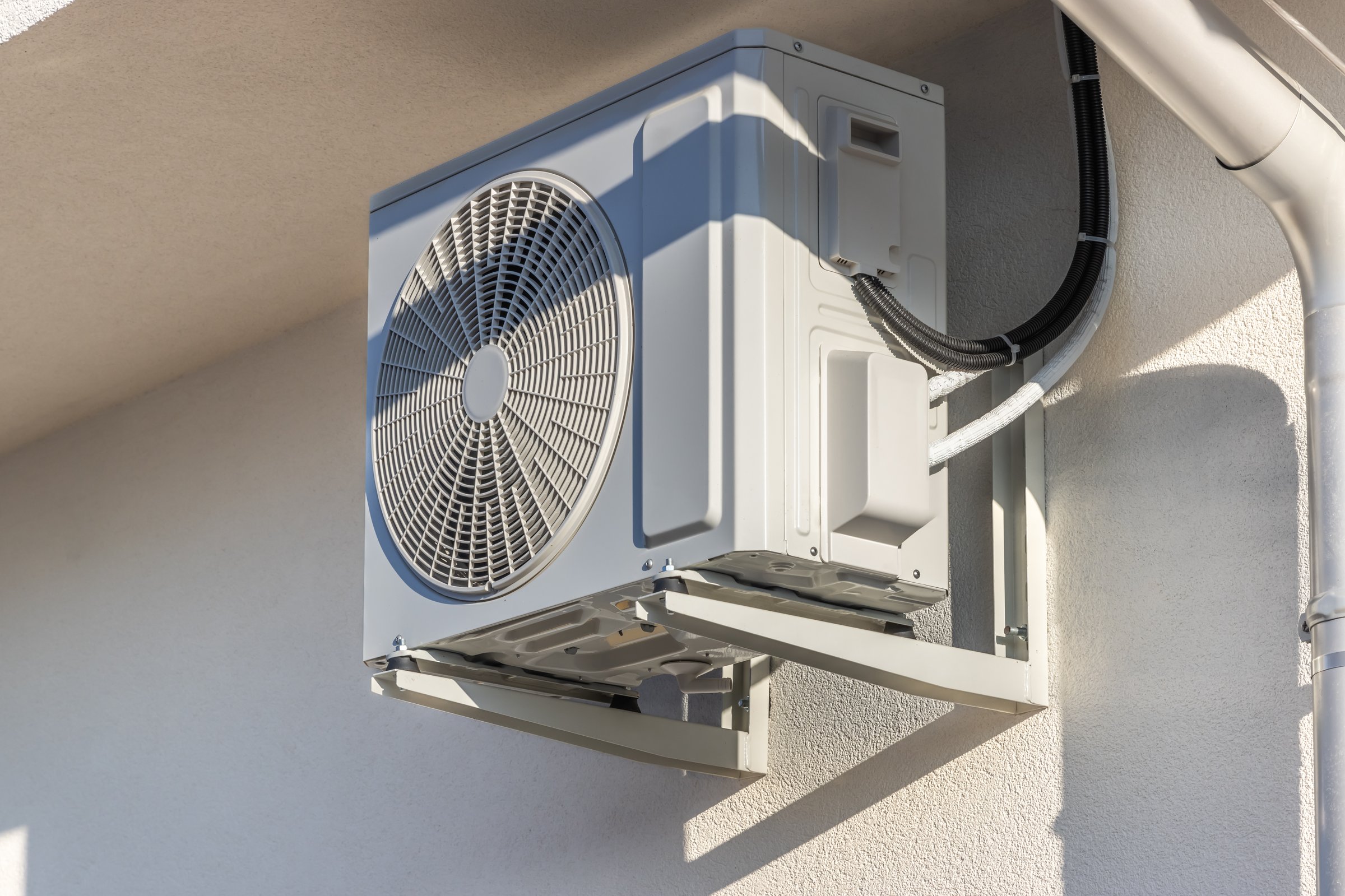 Air source heat pumps installed under a roof modern family house under construction, green renewable energy concept of heat pump