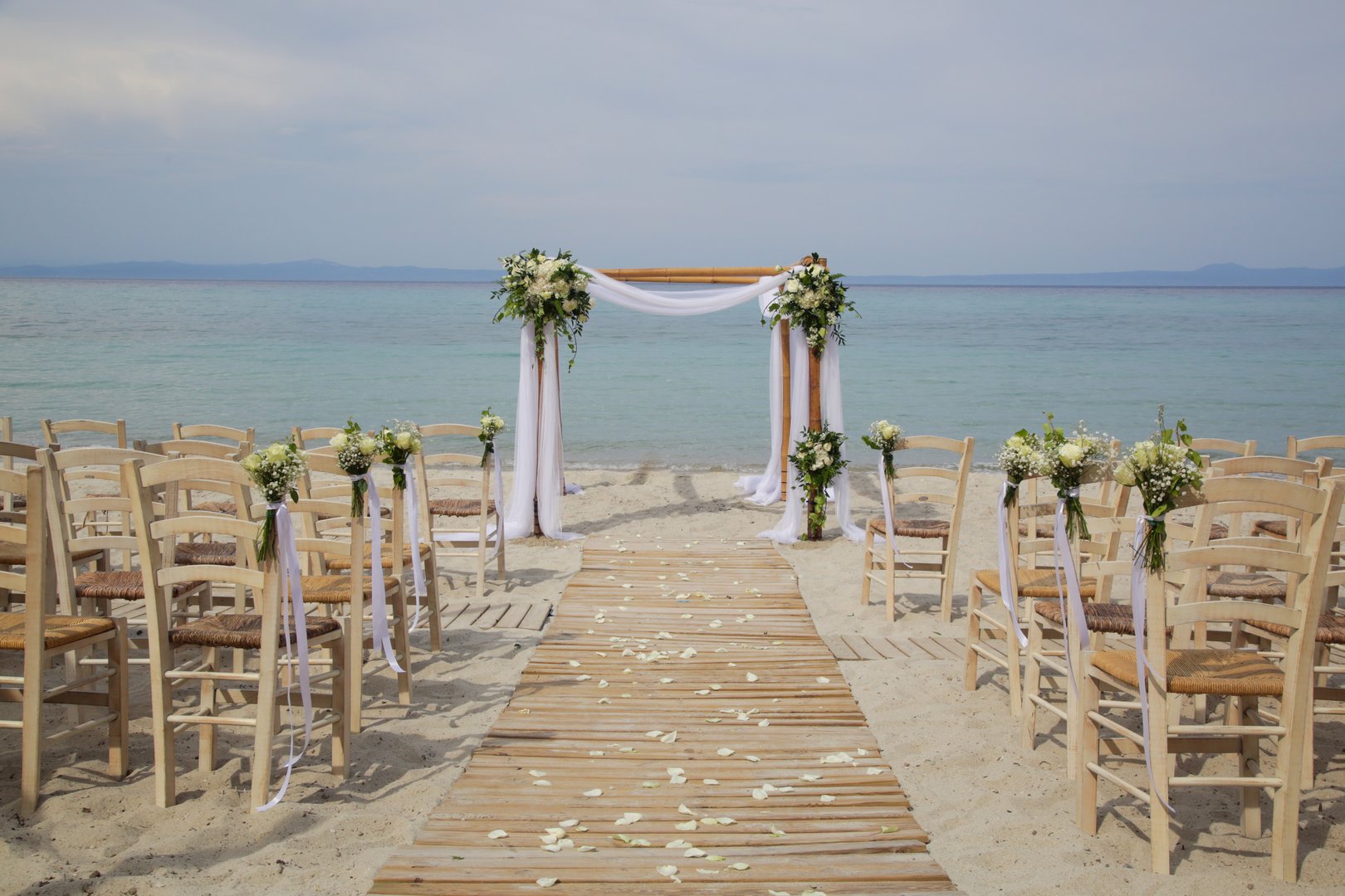 Outdoor beach wedding ceremony set up, beach wedding venue, no people, simple boho style
