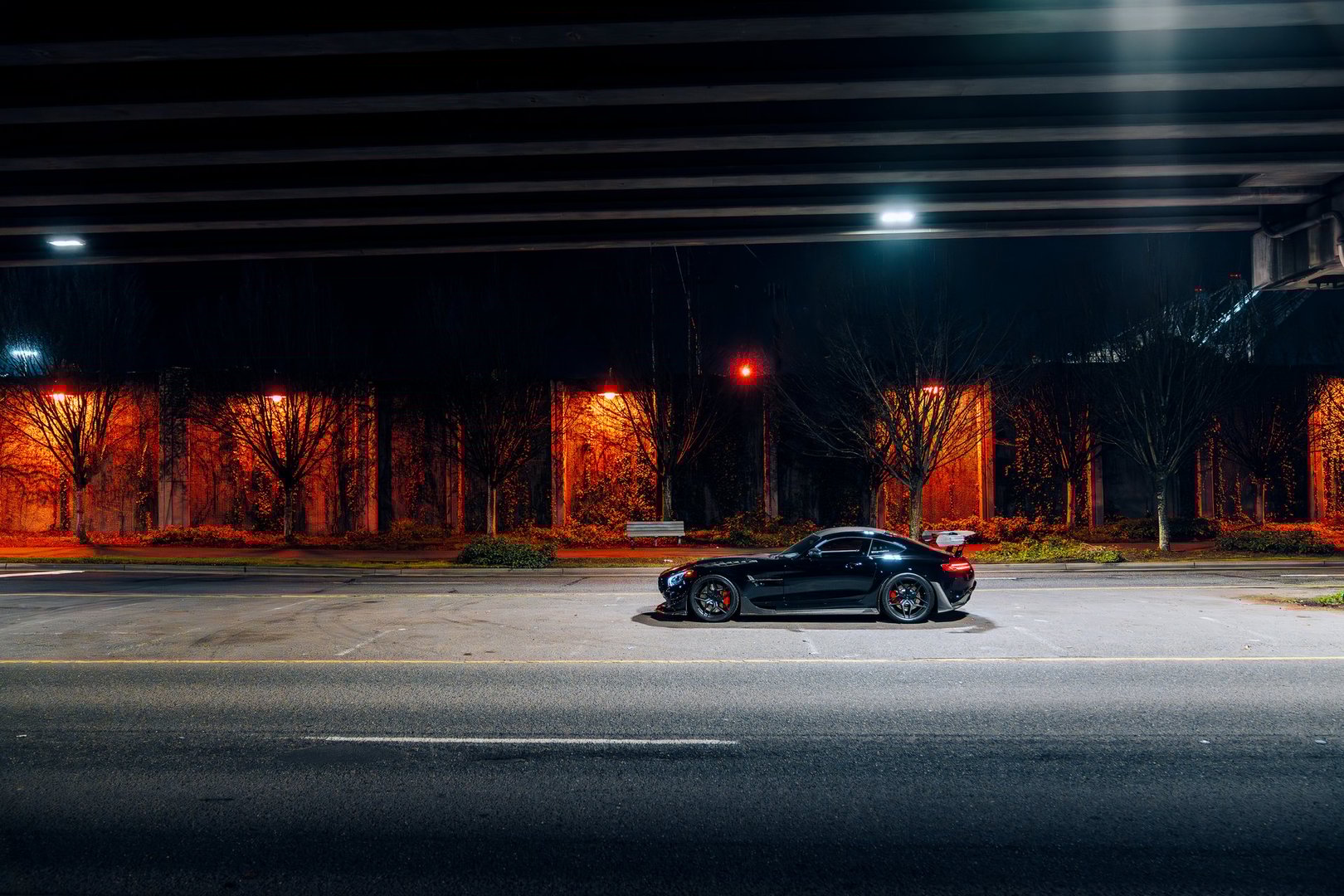 Seattle, WA, USAJanuary 25, 2025Black Mercedes AMG GTR showing the drivers side with a bridge above