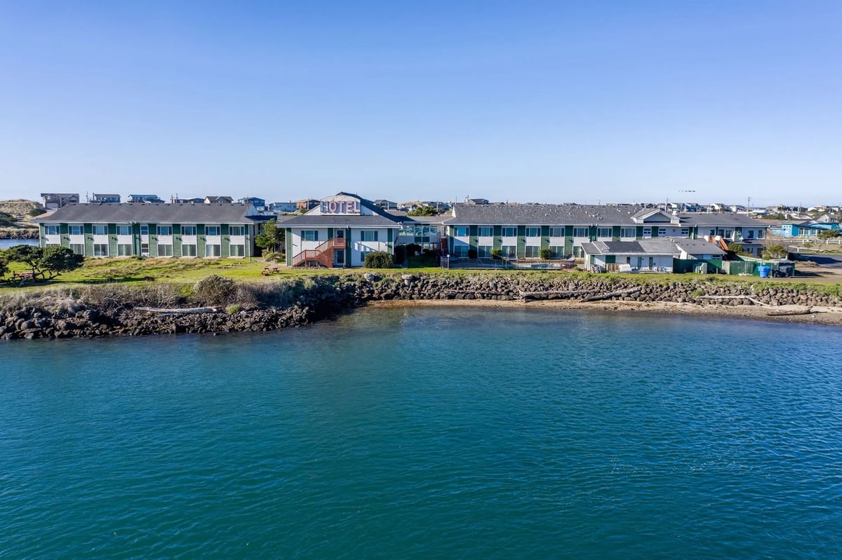 Drone shot of Alsi Resort highlighting the waterfront location and architecture