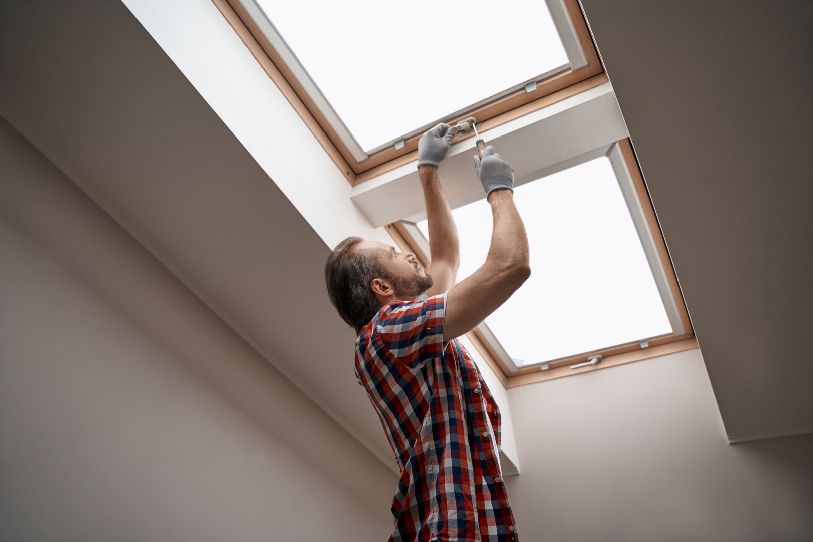 Worker installing skylight window