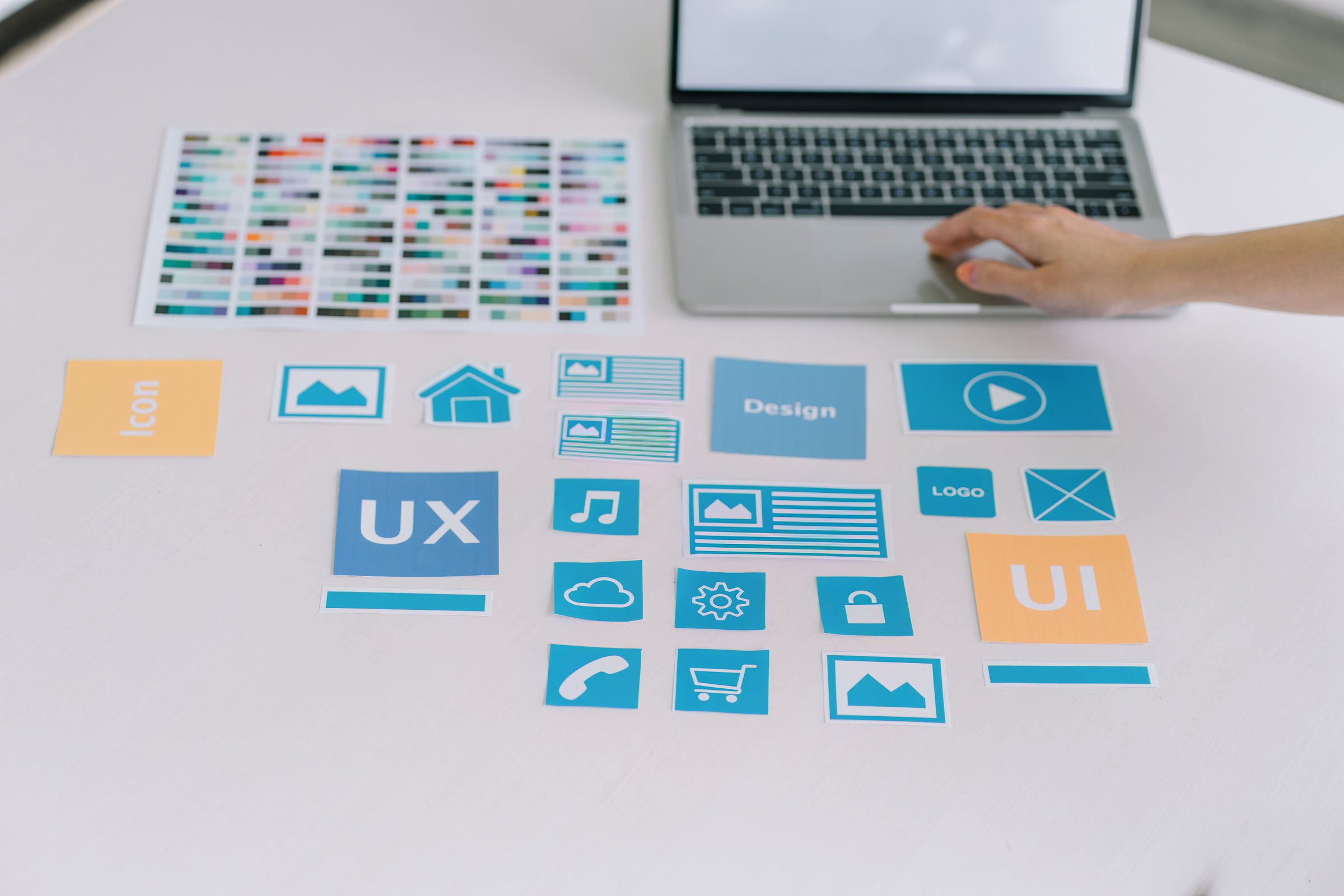 Creative UX UI designer working on screens for mobile responsive website development, focusing on UI UX. Developing wireframe sketch layout designs on a smartphone screen