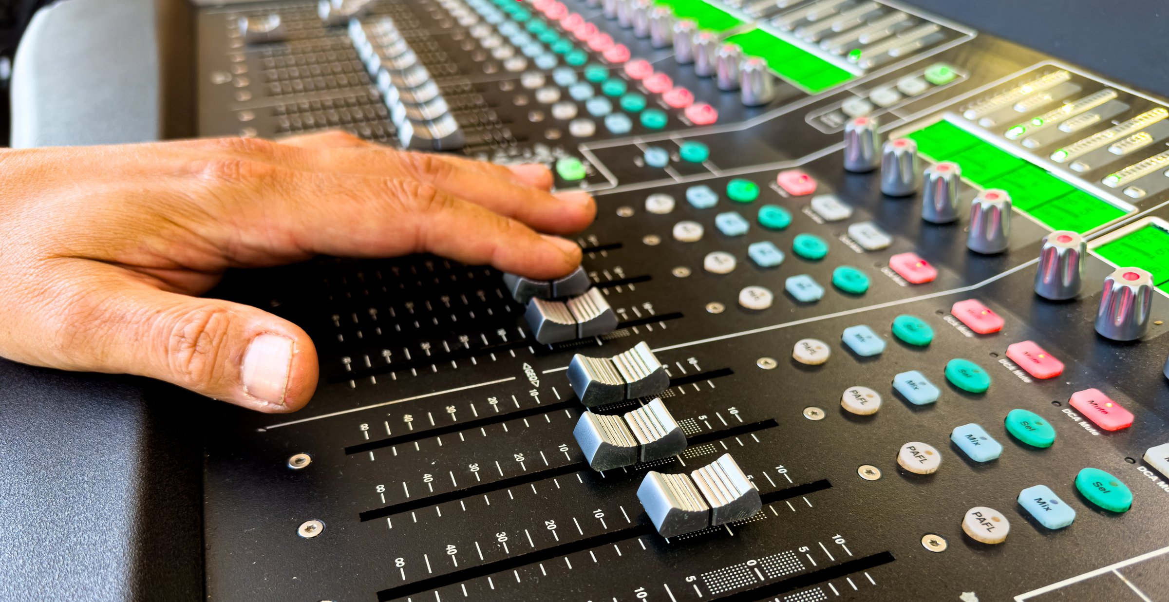 close up view of Sliders and buttons on Audio Mixing Desk at live event