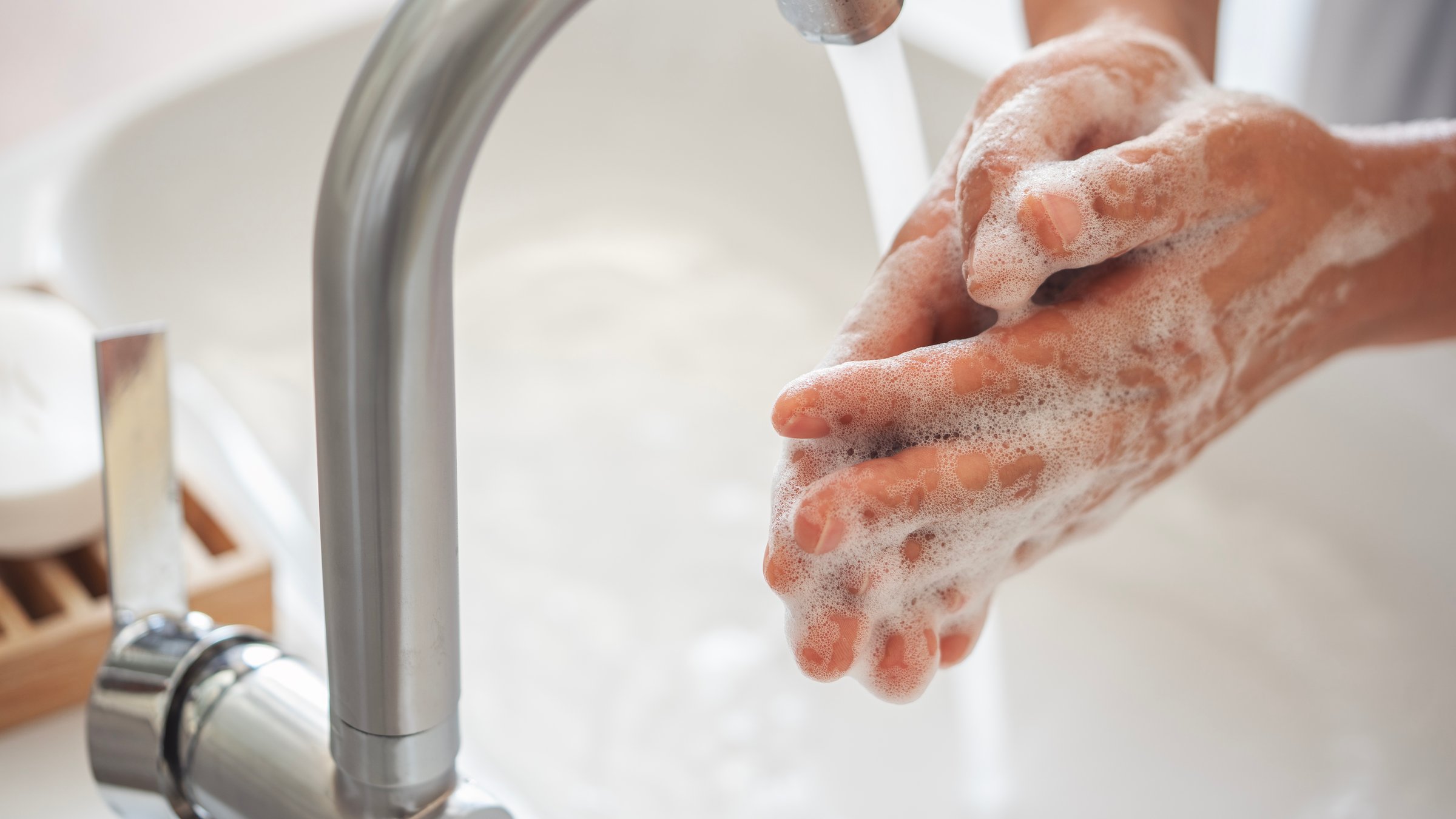 Woman washing her hands in the bathroom