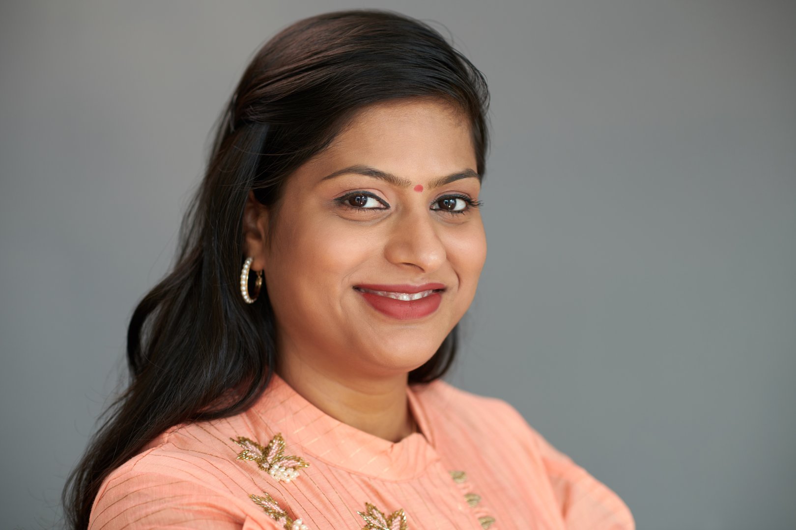 Mature Indian woman with bindi on forehead smiling in camera
