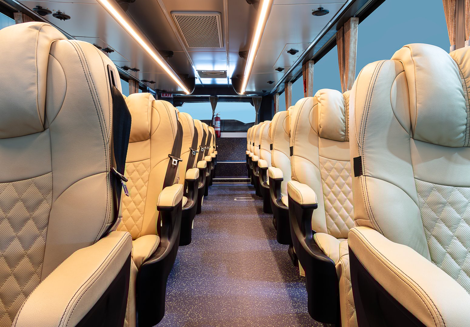 Inside bus with brown reclining seat row