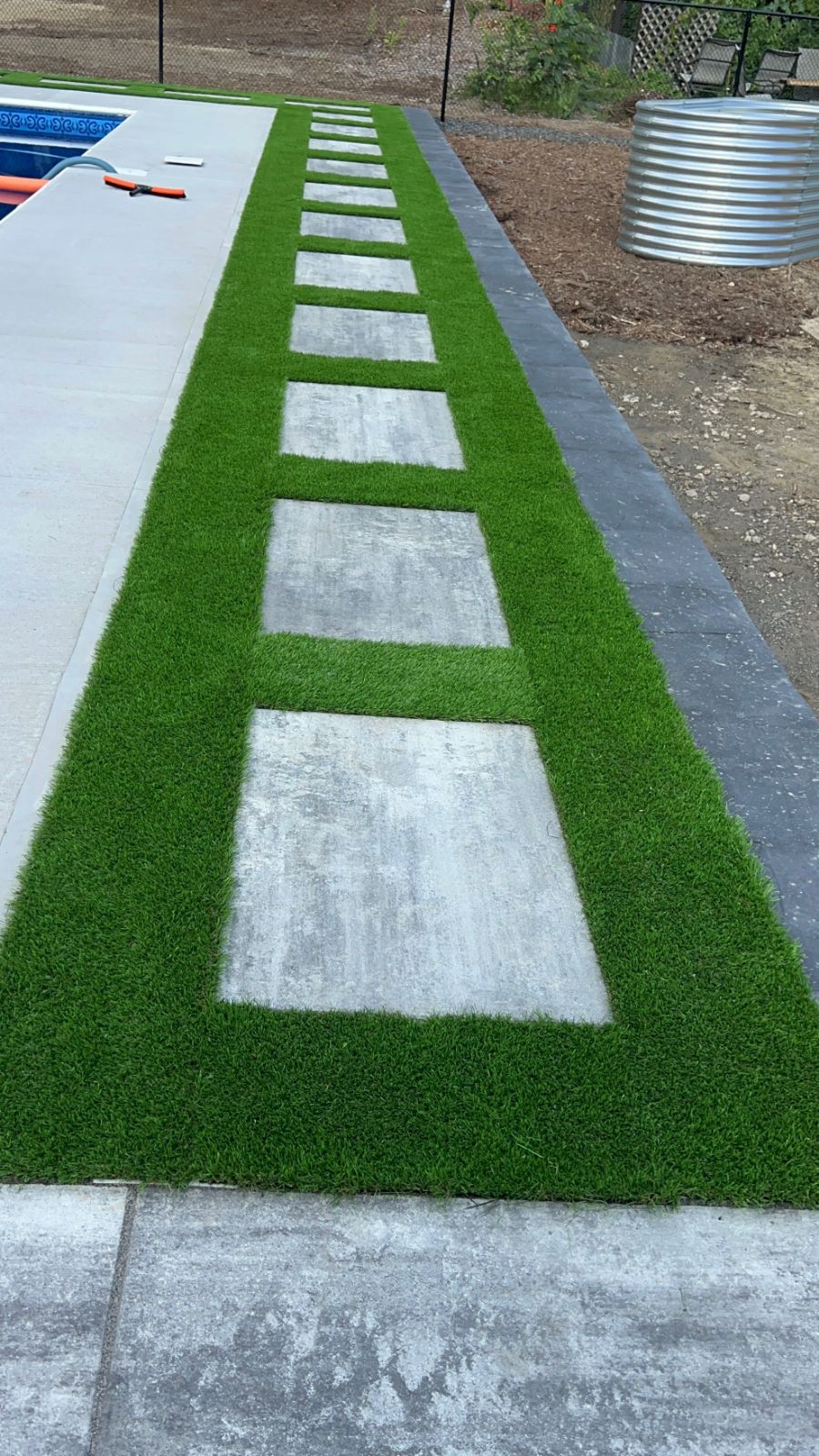 Pool paver installation completed with grass