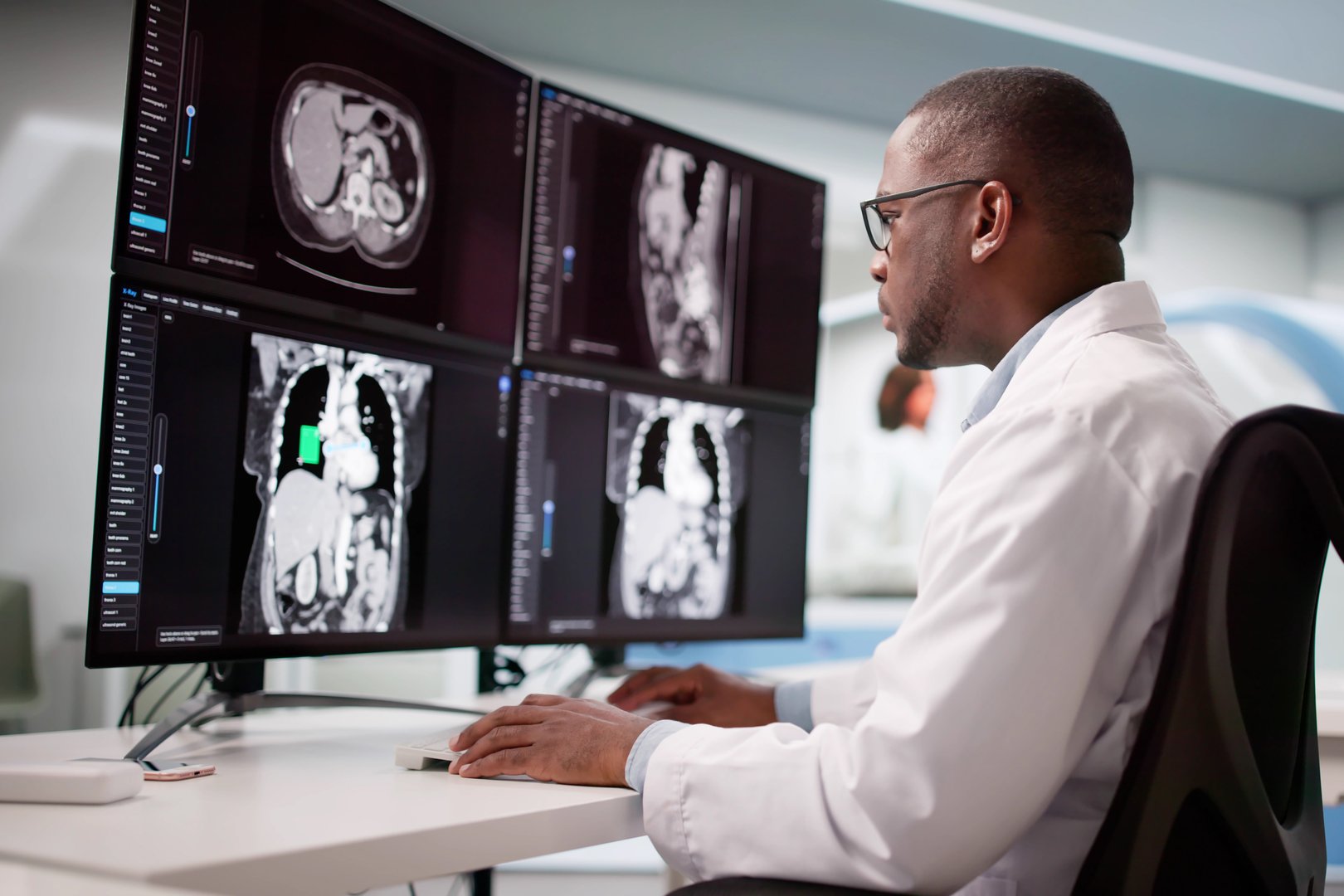 Skilled Surgeon Analyzing MRI Scan Using Desktop Computer In Hospital.