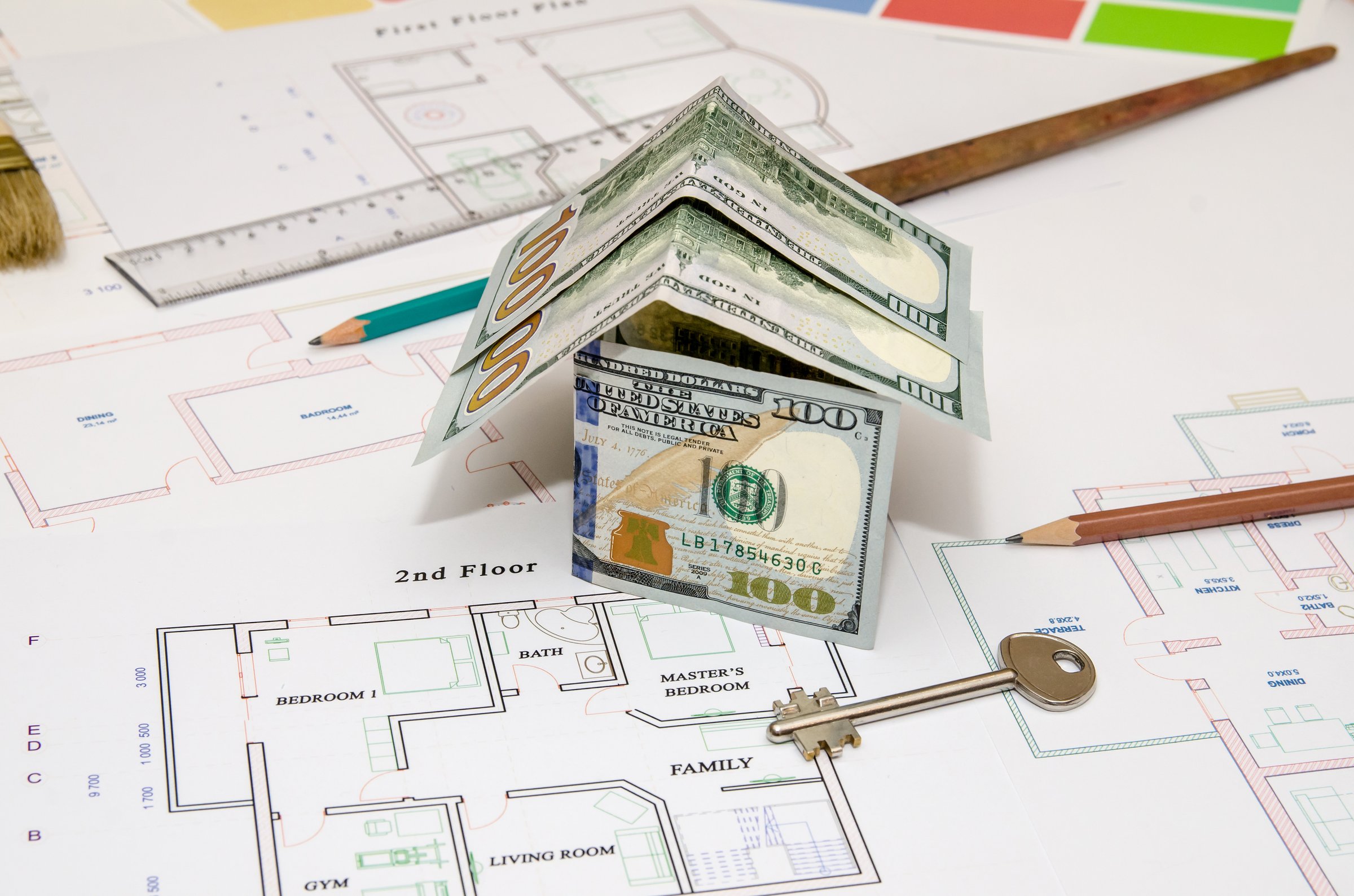 Construction plan, pen, money, model house