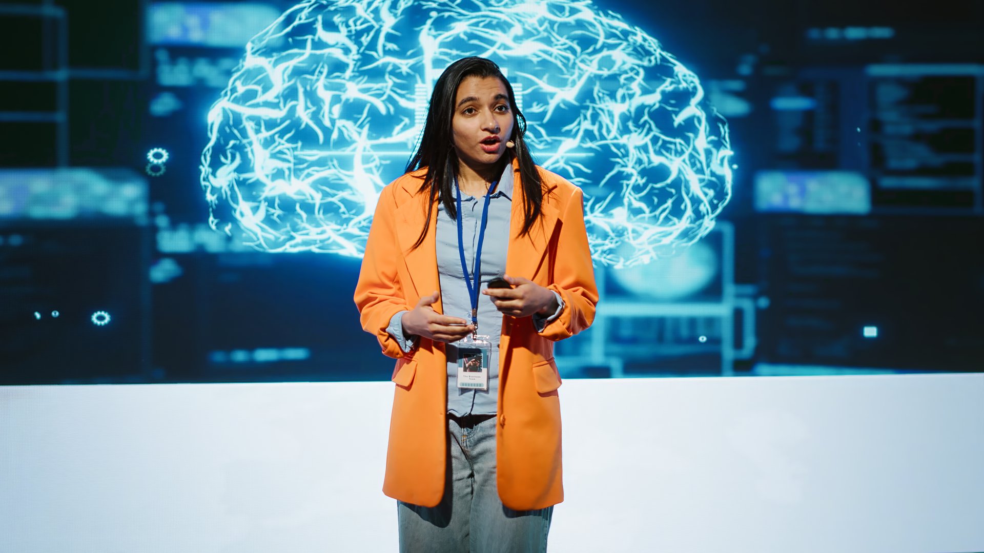 Speaker talking with audience on stage at AI conference bringing together leading experts and researchers to explore latest developments in artificial intelligence and machine learning, camera A
