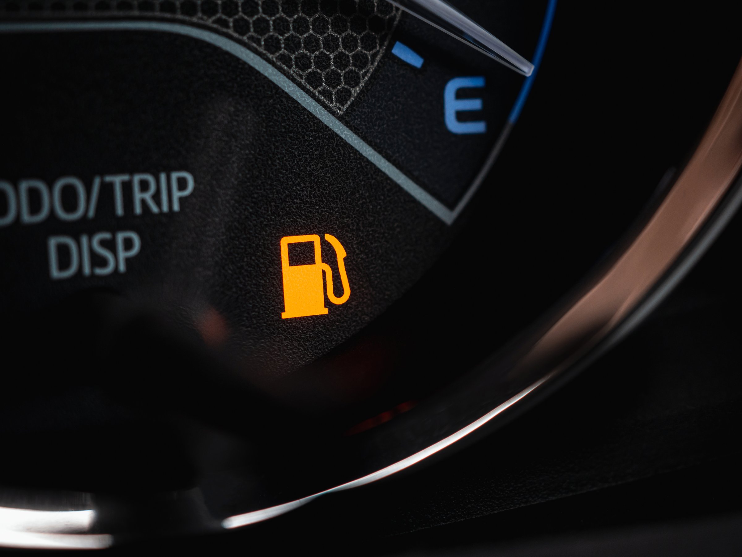 Close-up of empty fuel warning light in car dashboard. Fuel pump icon. gasoline gauge dash board in car with digital warning sign of run out of fuel turn on. Low level of fuel show on speedometer dashboard.